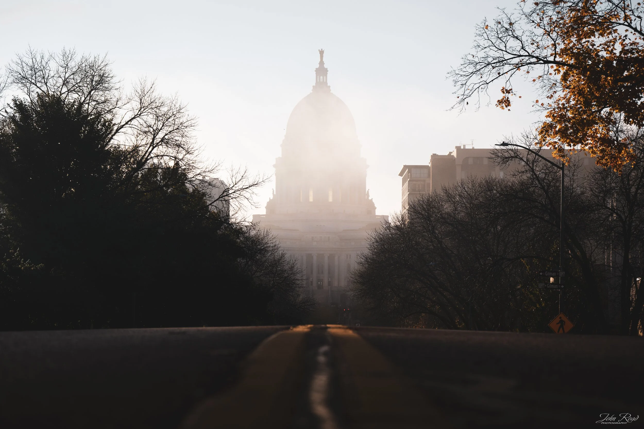 Fine art photograph of the Capitol building covered in morning fog, soft light over the city captured by John Road.