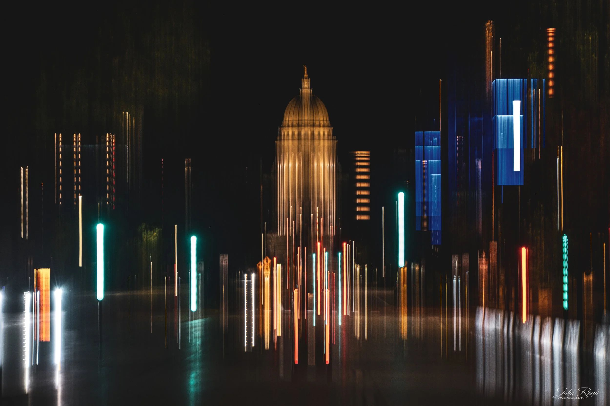 Vertical multicolored light trails blur the Wisconsin State Capitol at night in this abstract intentional camera movement photograph from Madison, Wisconsin.