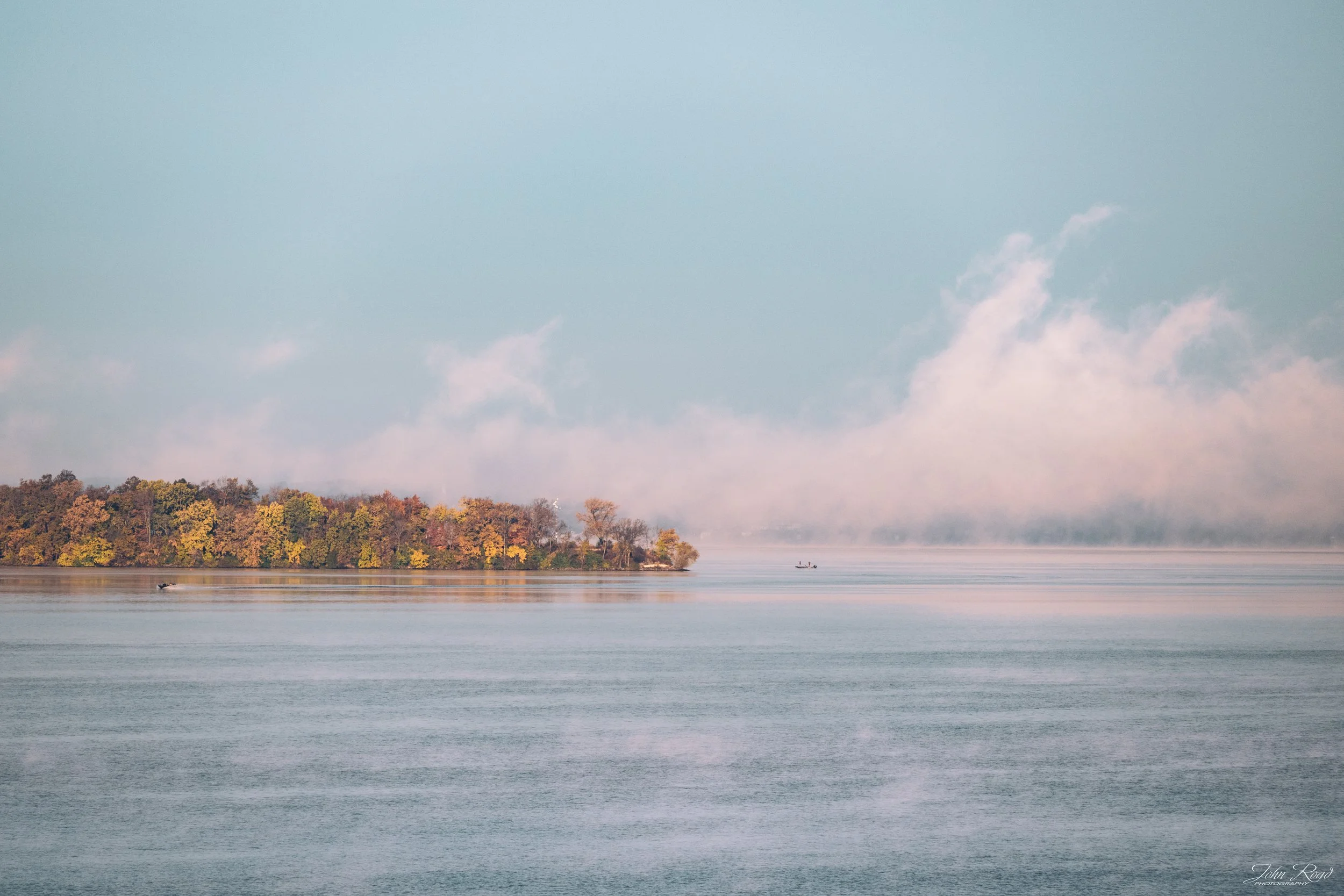 Fine art photograph of a foggy lake at dawn, calm waters and soft mist captured by John Road.