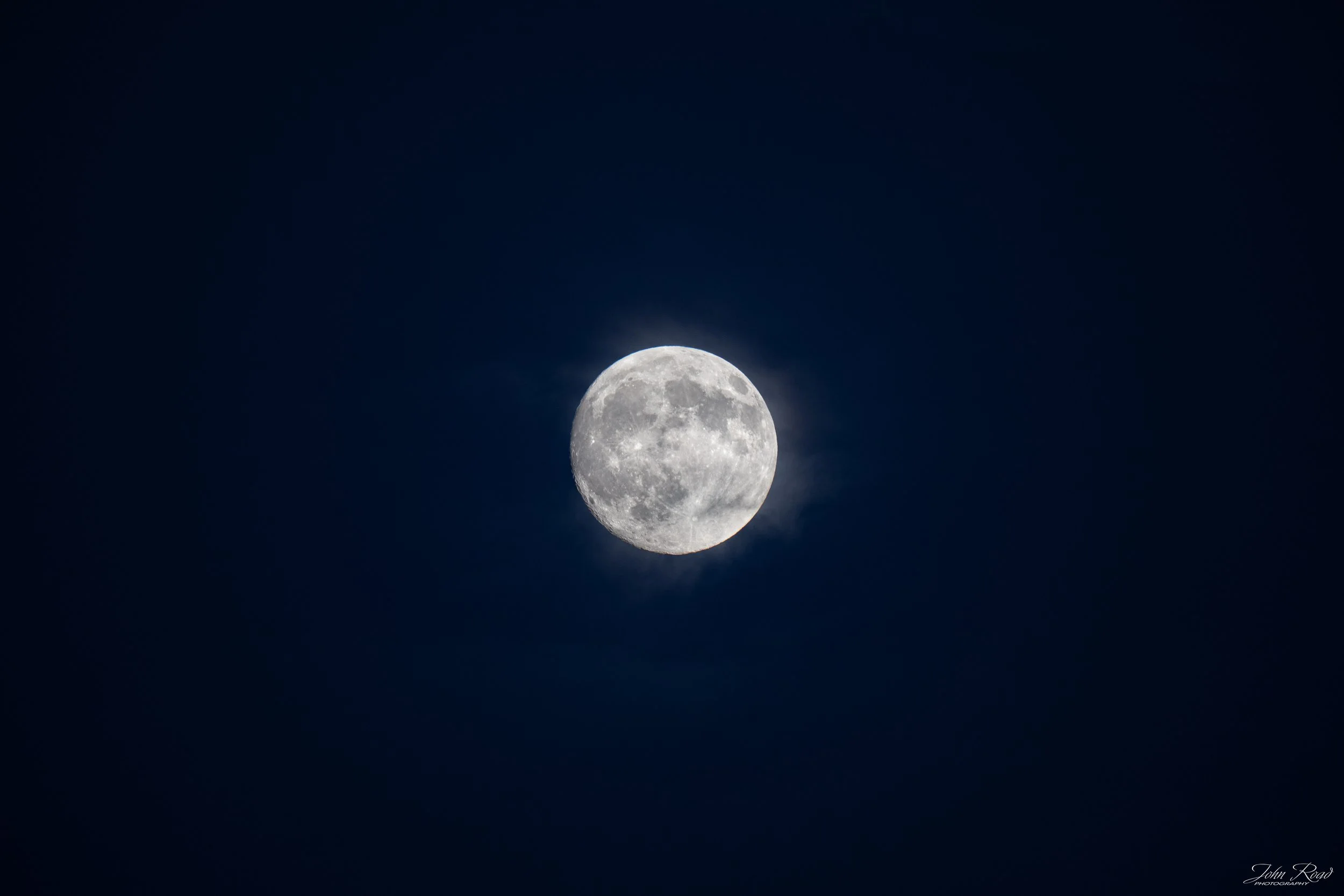 Fine art photograph of the full Harvest Moon glowing in the night sky, captured by John Road.