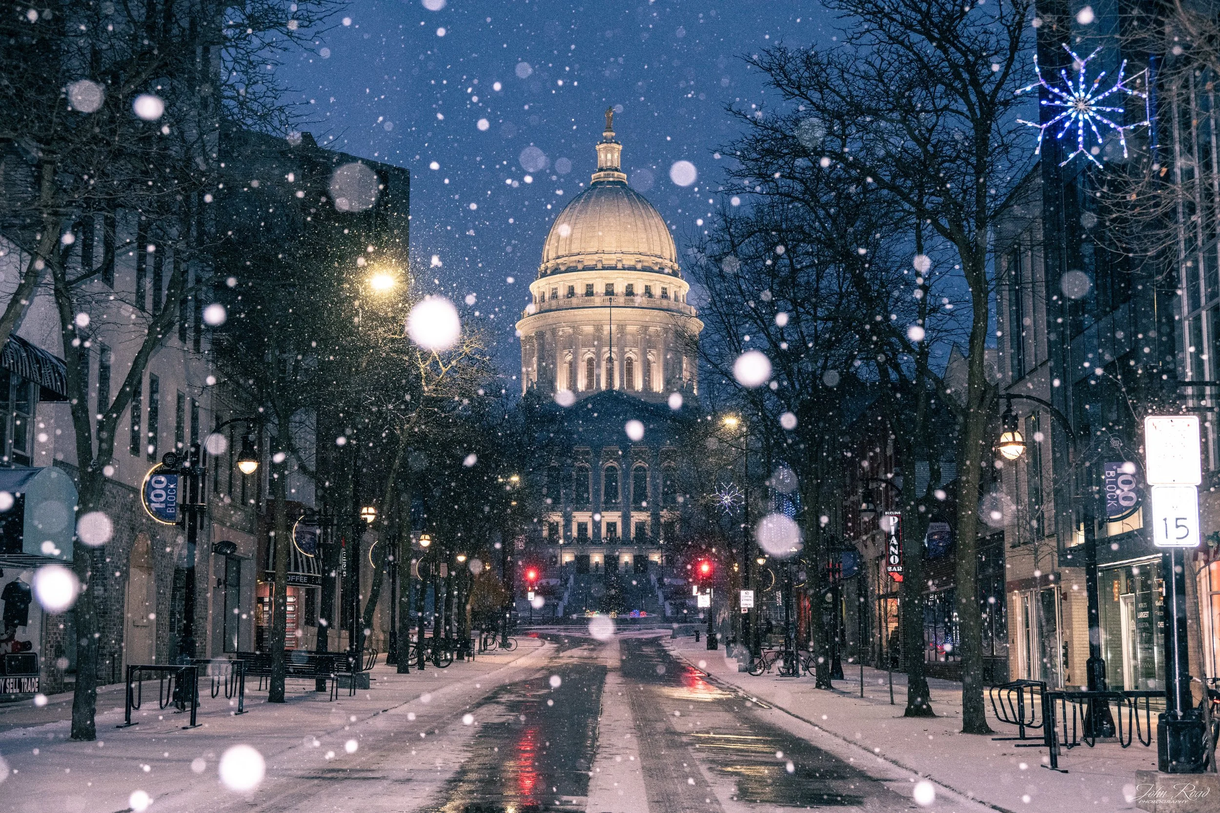Snowy State Street in Madison with the Wisconsin Capitol in the background, photographed by John Road.