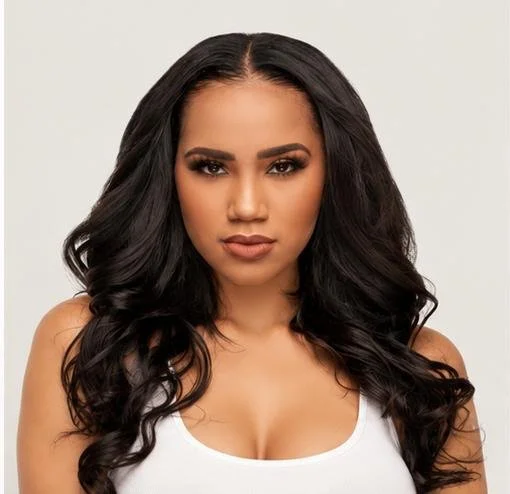 A woman with long, dark, wavy hair and a neutral expression wearing a white sleeveless top against a plain background.