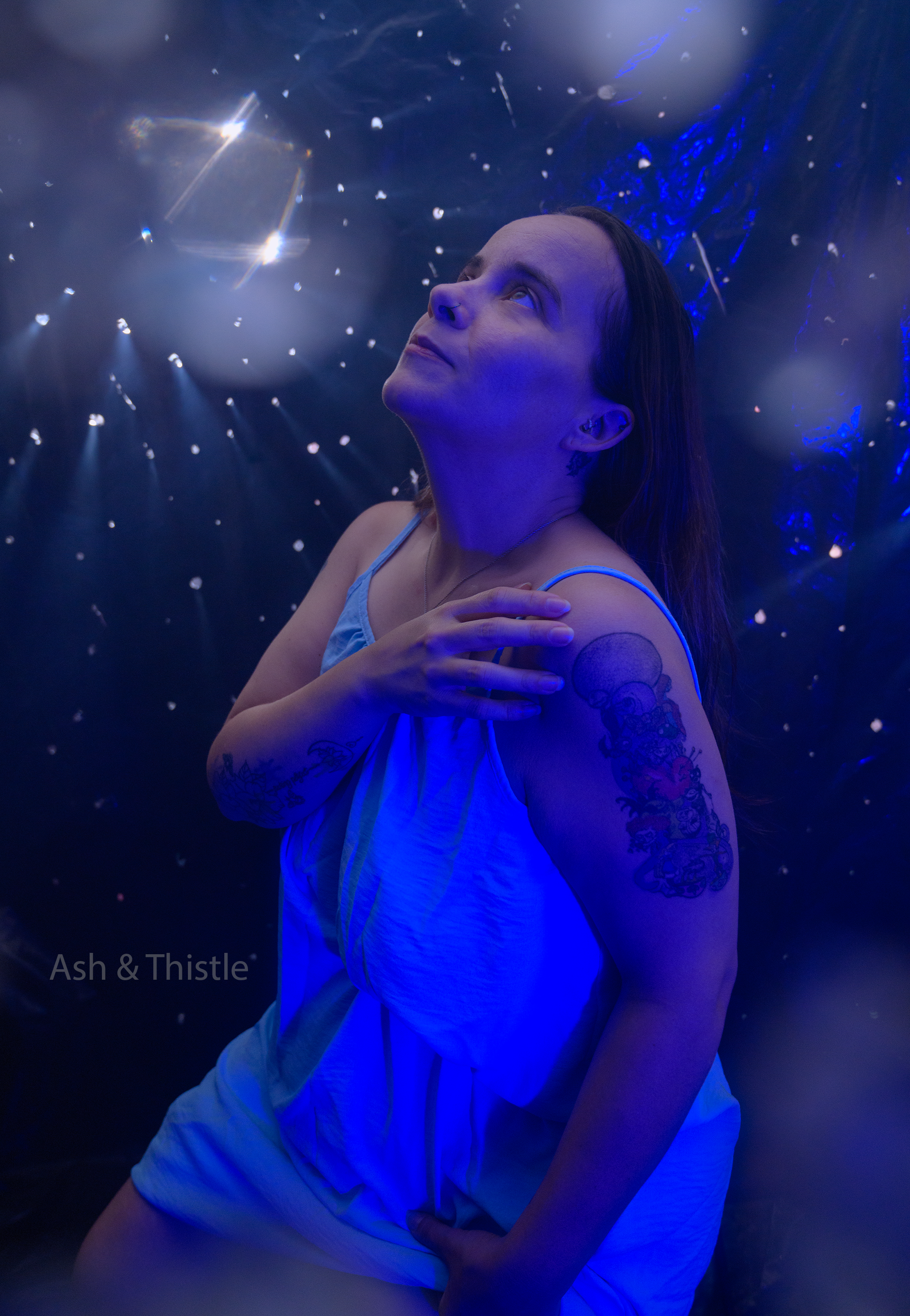 Fantasy photography a woman in blue light with light spraying prism effects