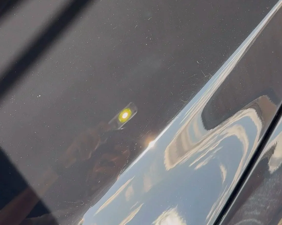 Using a torch to check paintwork for swirl marks