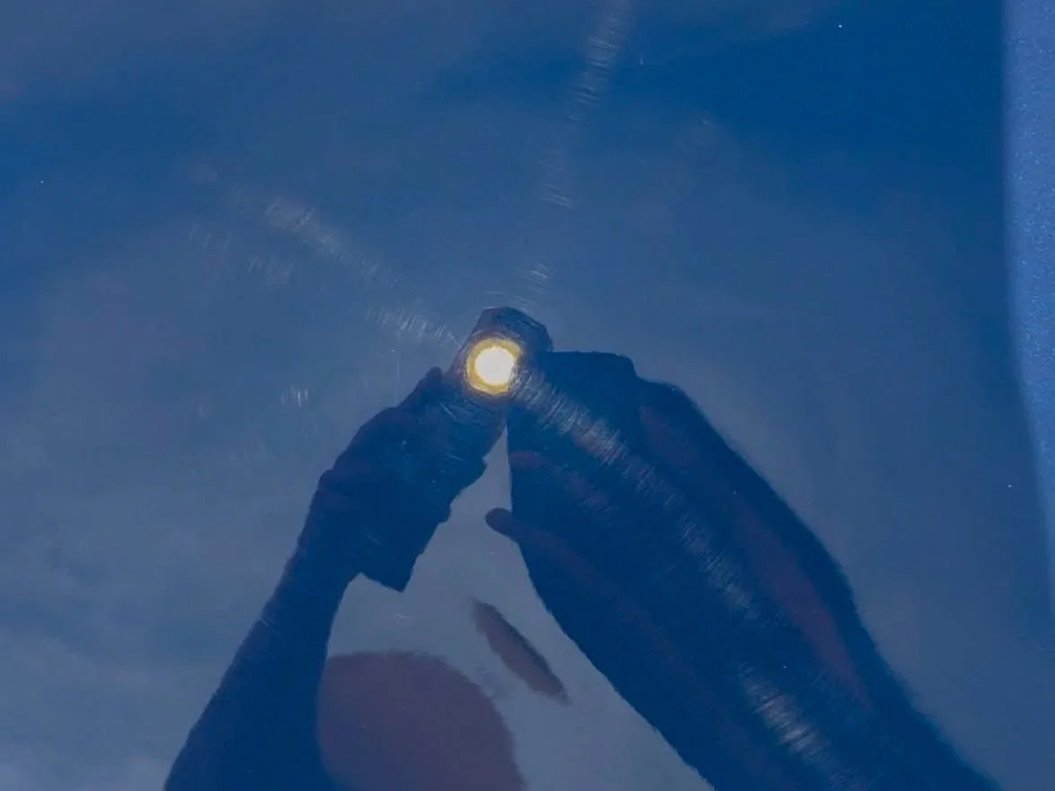 Swirl marks visible under inspection light before paint correction