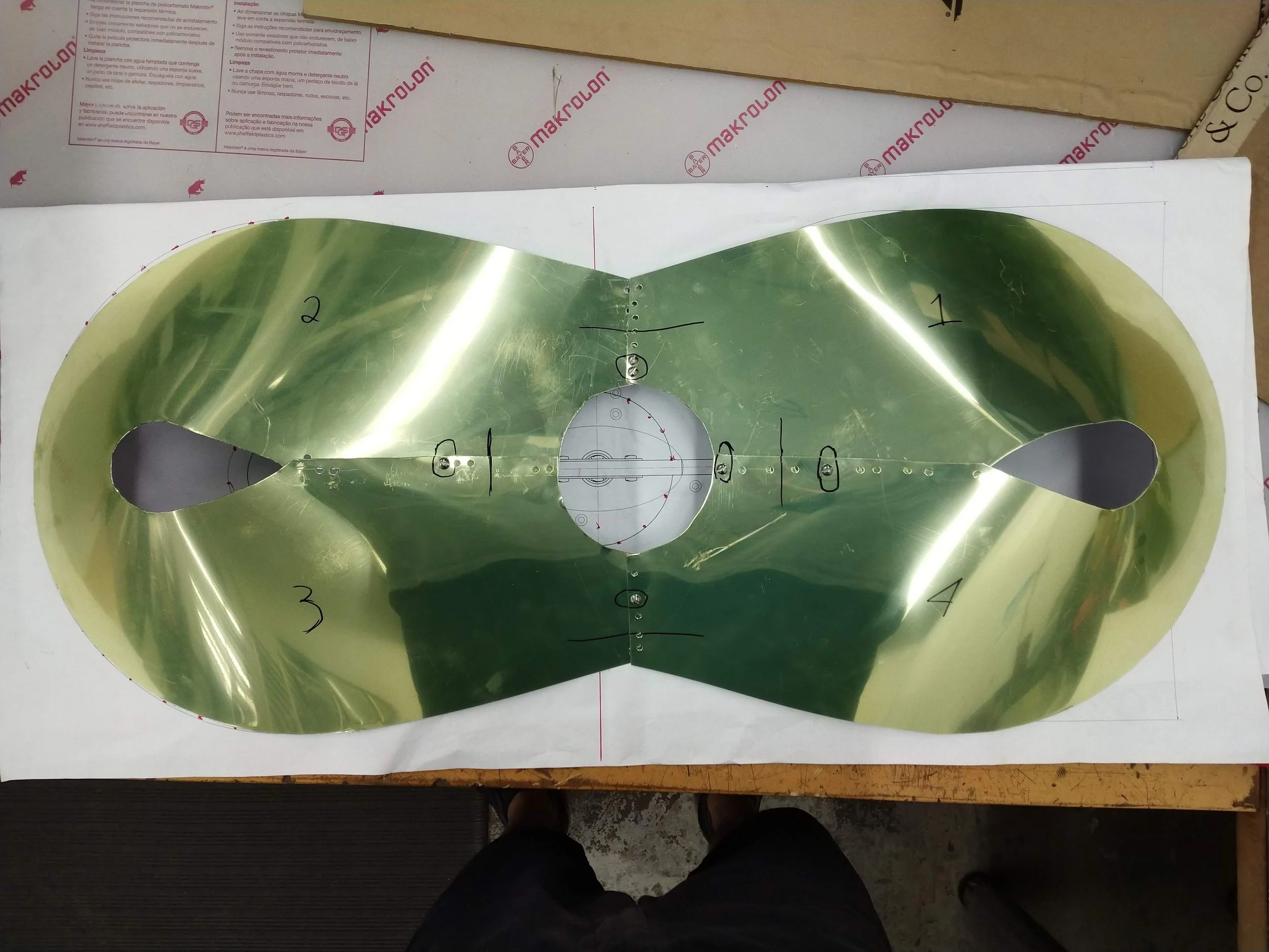 Approved aluminum sheet metal prototype overlaid on 1:1 printout to confirm dimensions