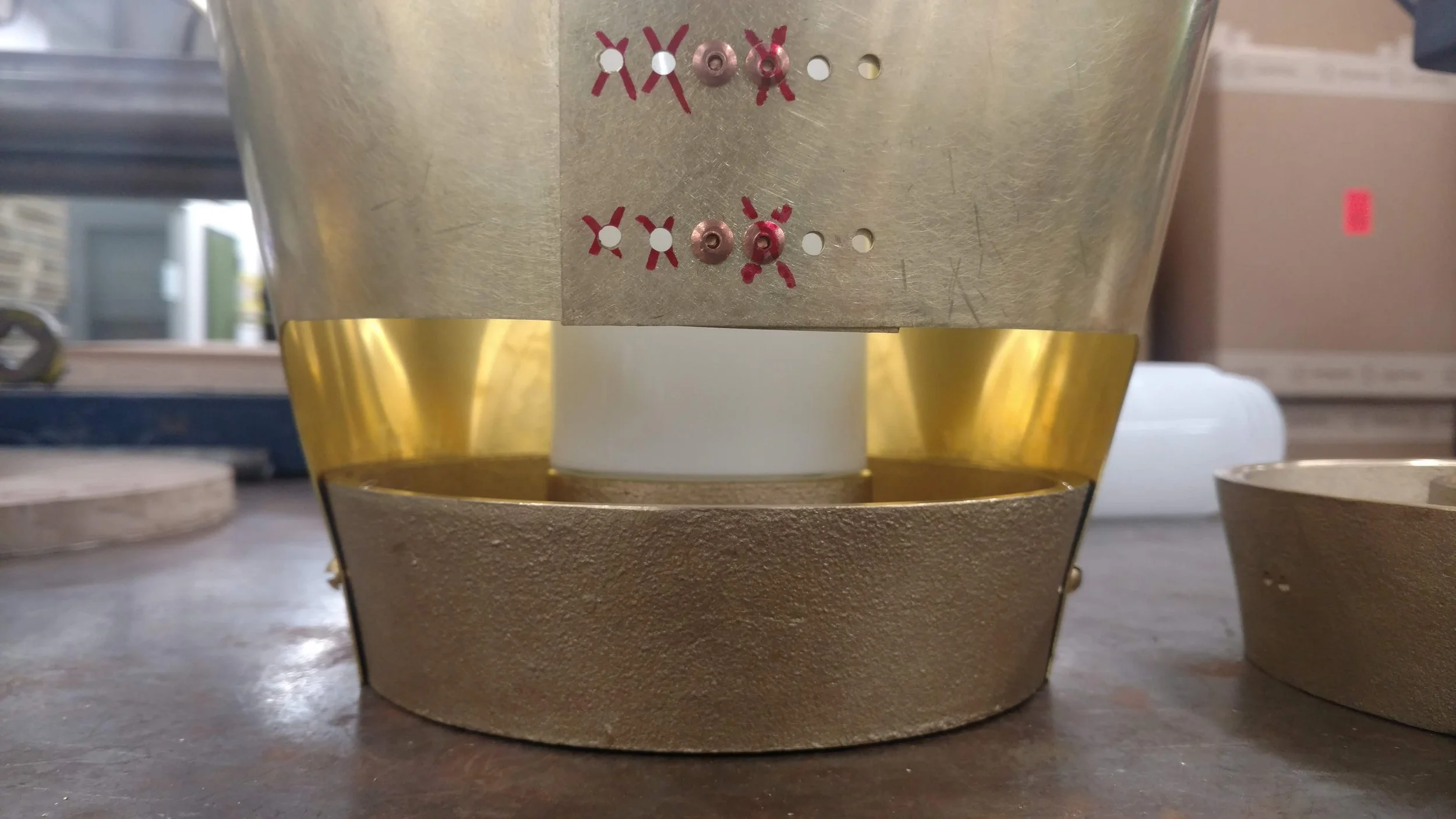 Testing several hole locations to find optimal rivet hole locations