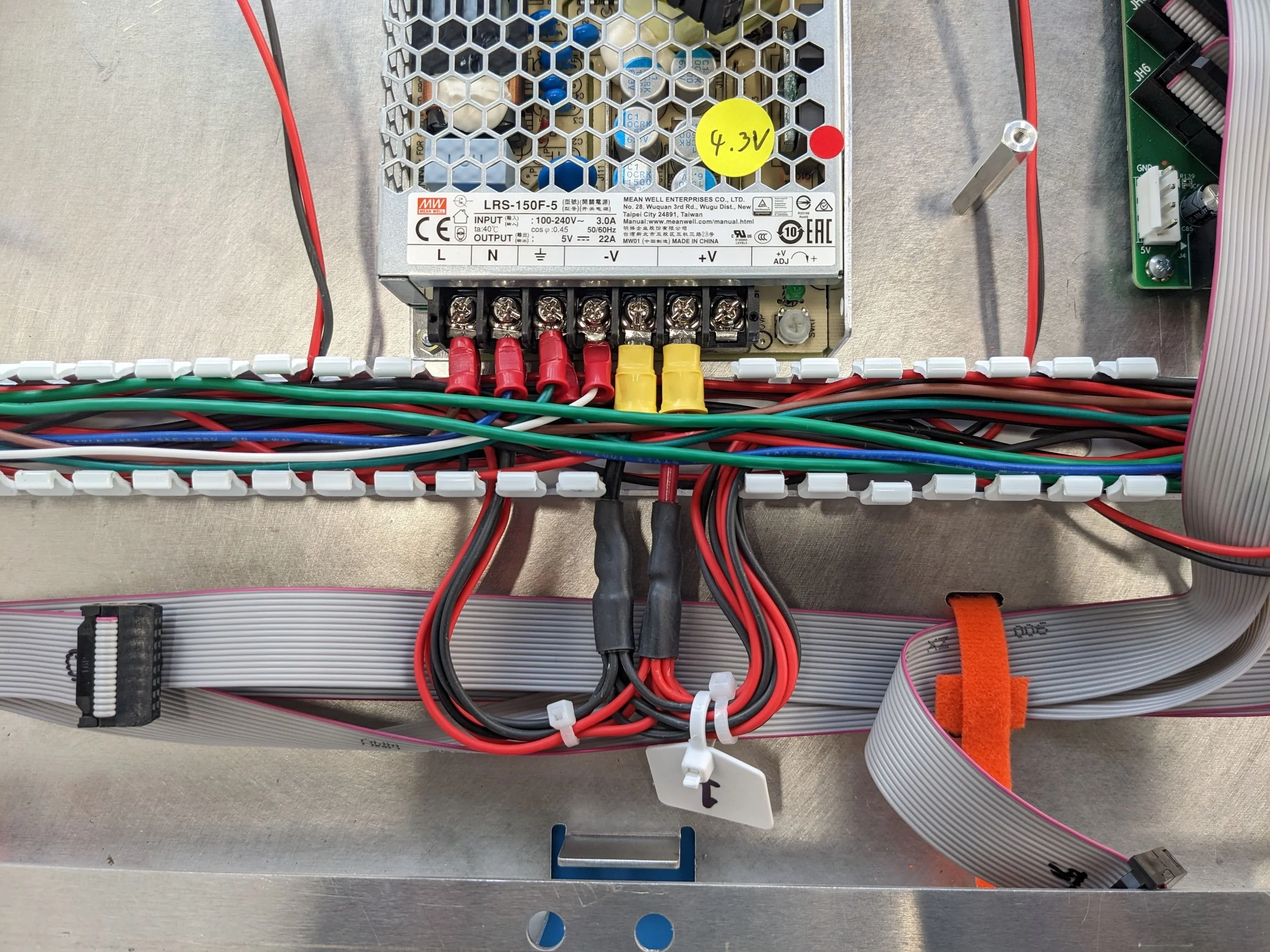 Close-up view of one of four Power Supplies with tidy cables. The Power Supply steps down voltage from 120V to 4.3V to power the LED tiles and Data Cards. Power and Ethernet cables were daisy-chained between Power Supplies and Data Cards.