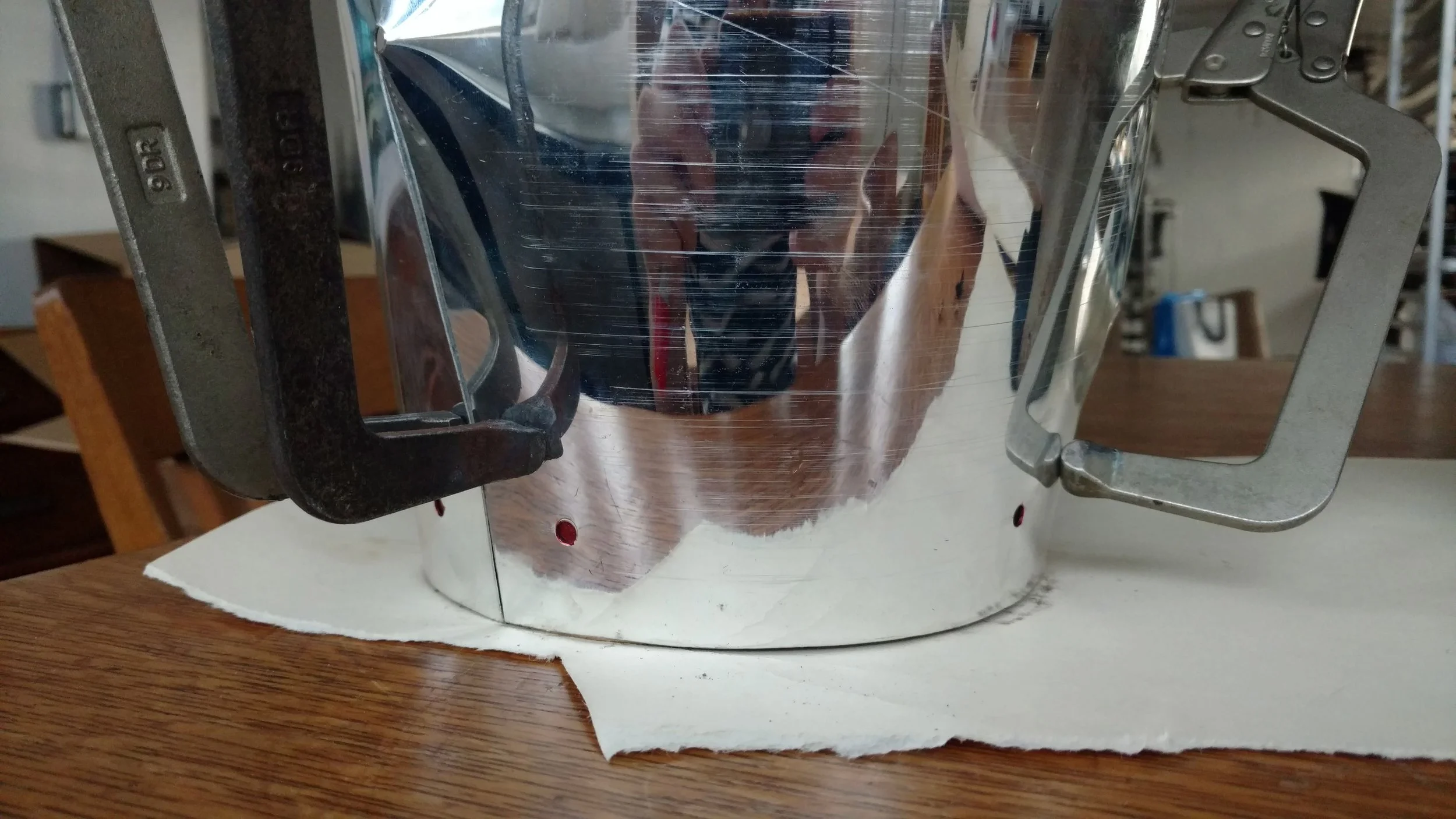 Clamped-down aluminum Shade prototype to locate corresponding tapped holes in Base