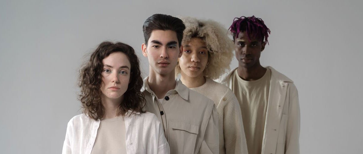 Men and women in beige and white outfits standing in line