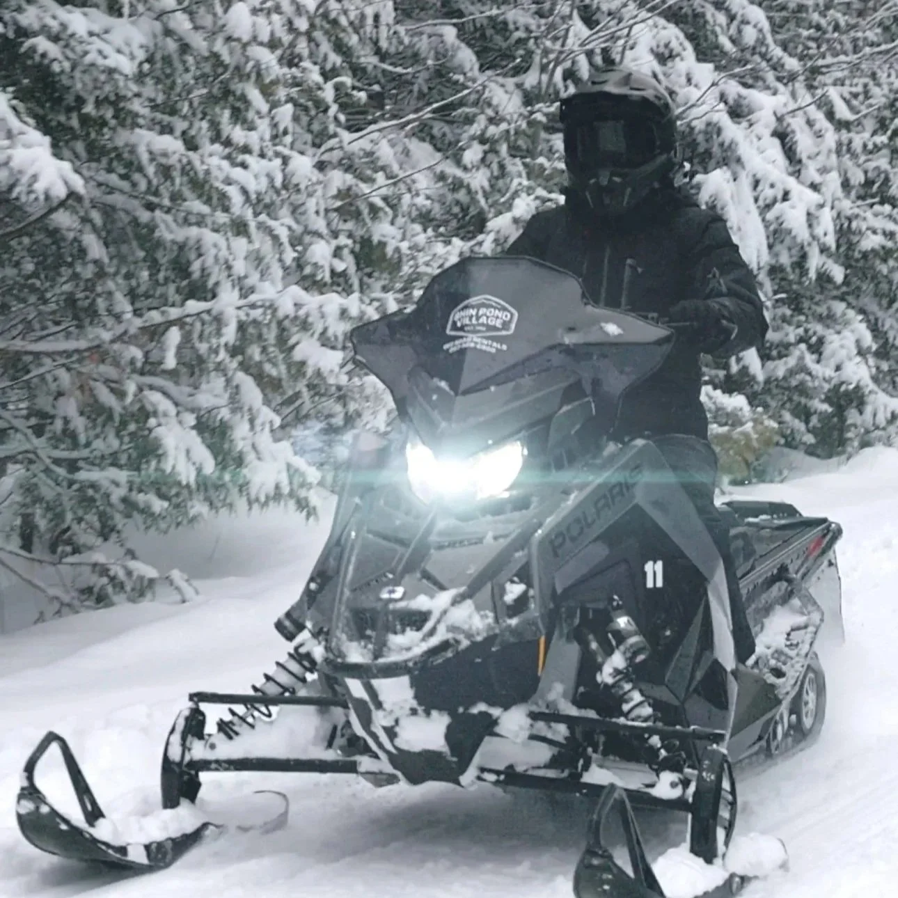 Snowmobiler riding on groomed trails