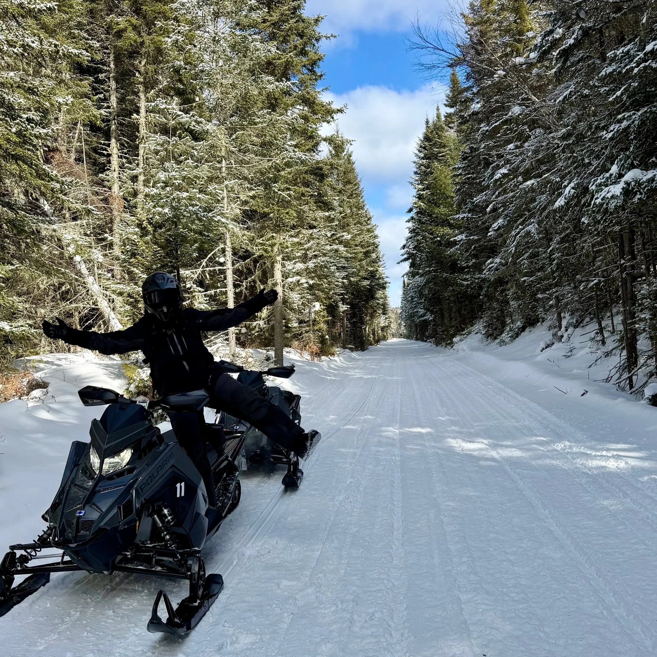 Rented snowmobile with groomed trails in the background