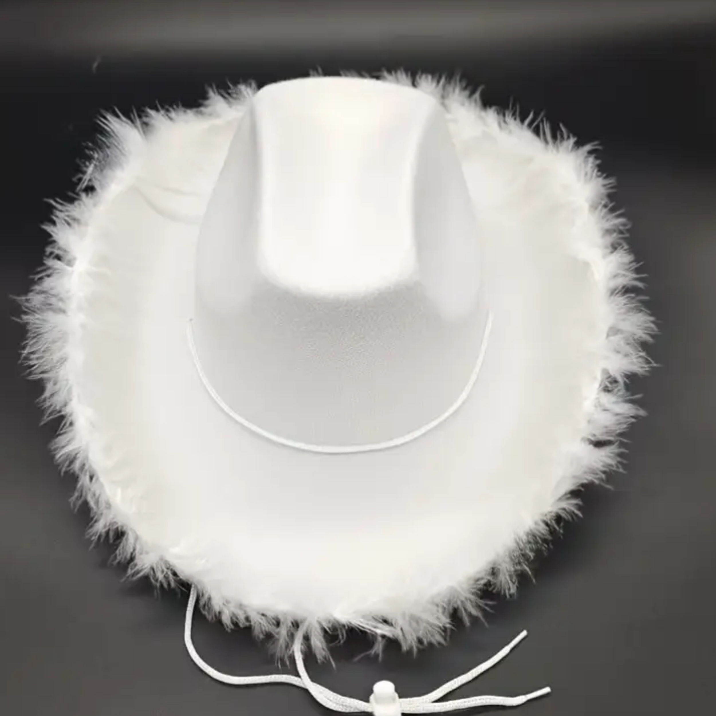 A white fluffy earmuff with a satin band in the middle.
