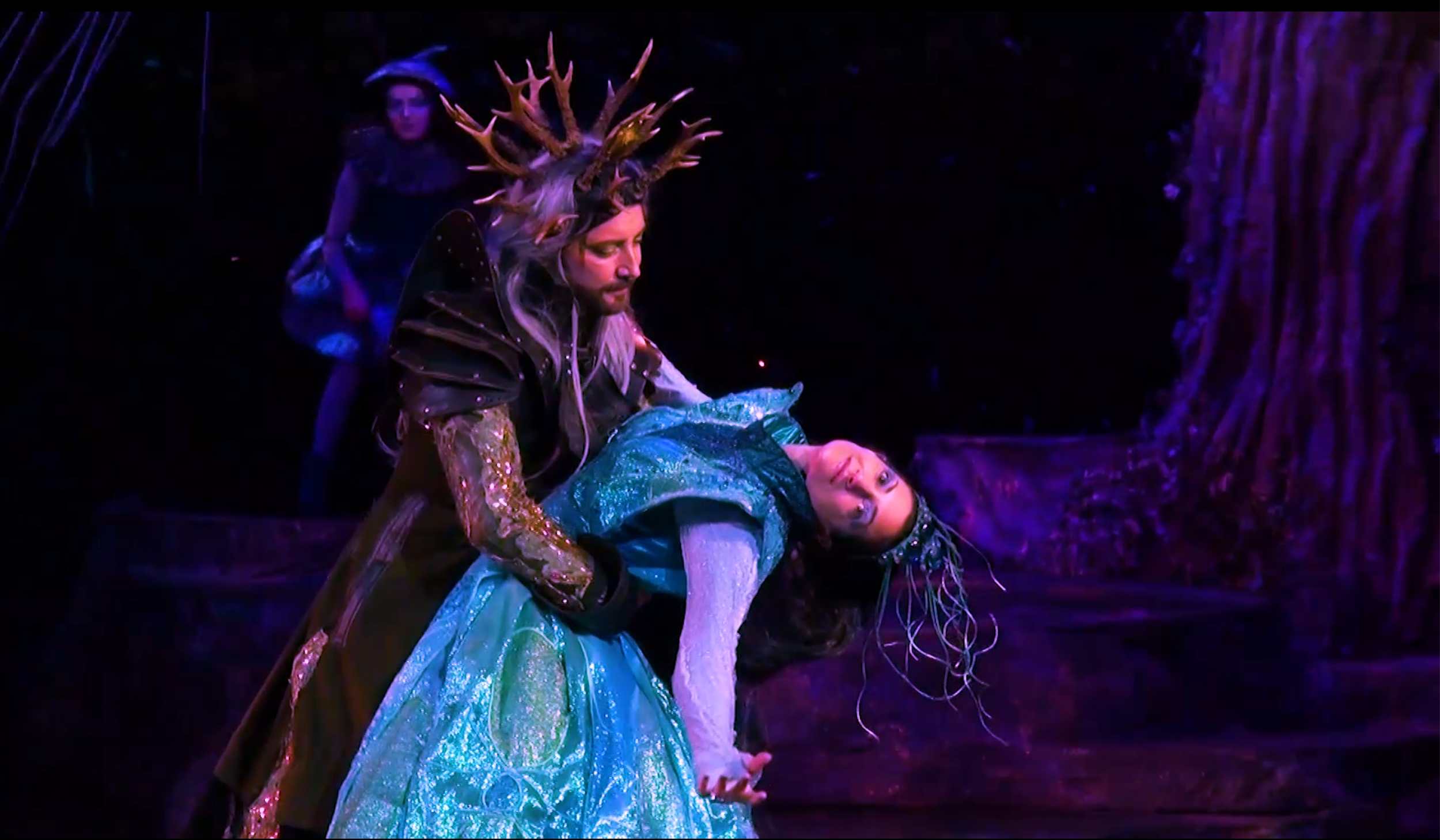 Drama scene: Oberon and Titania from "A Midsummer Night's Dream," captured dancing.