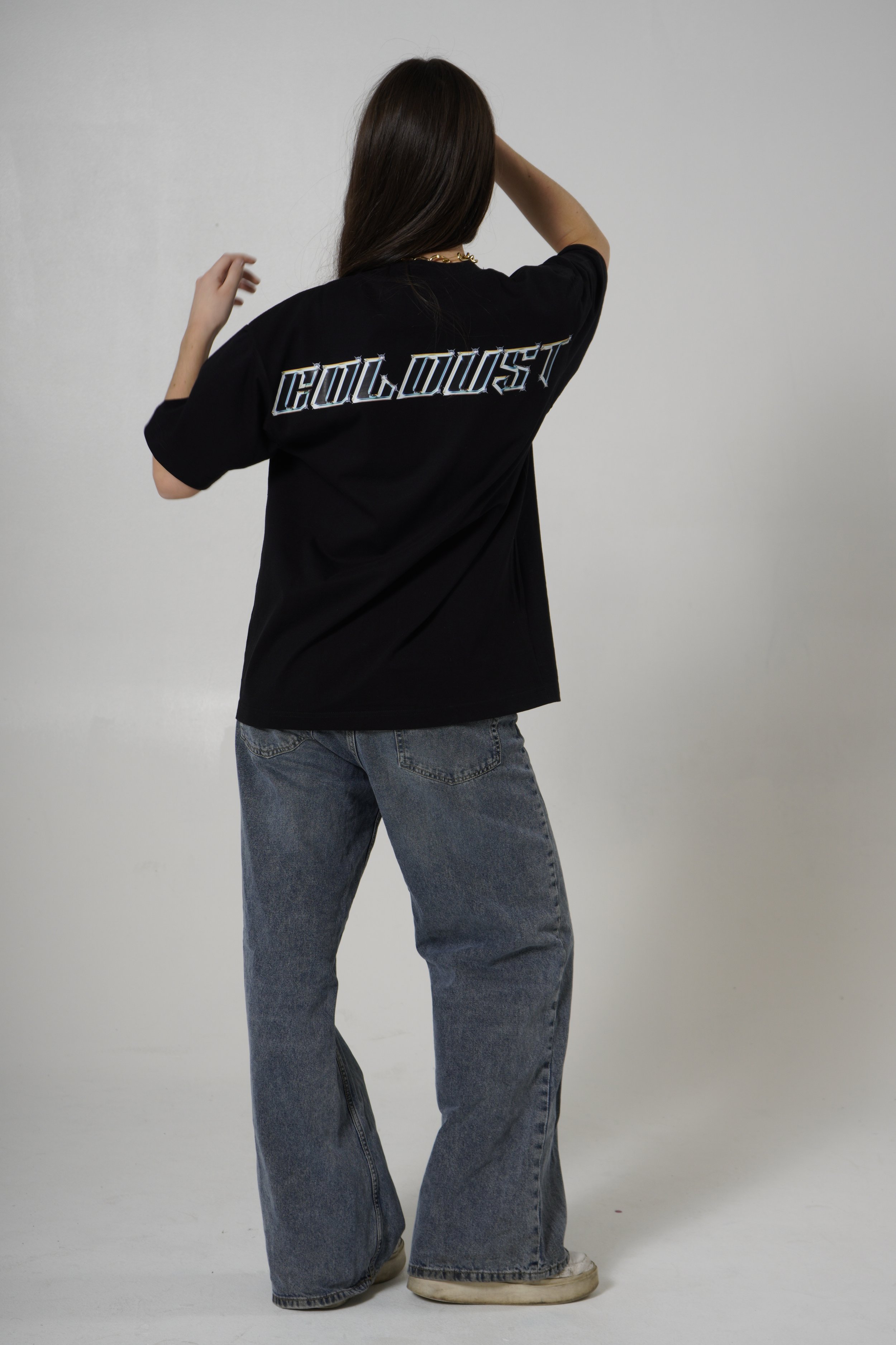 Woman showing the back view of black t-shirt