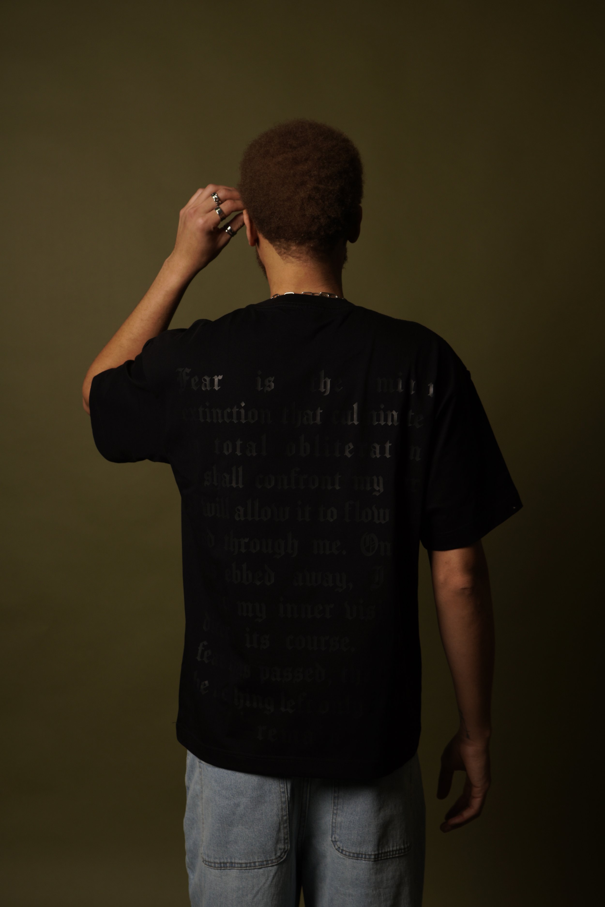 Rear view of black tee on model – simple and stylish look