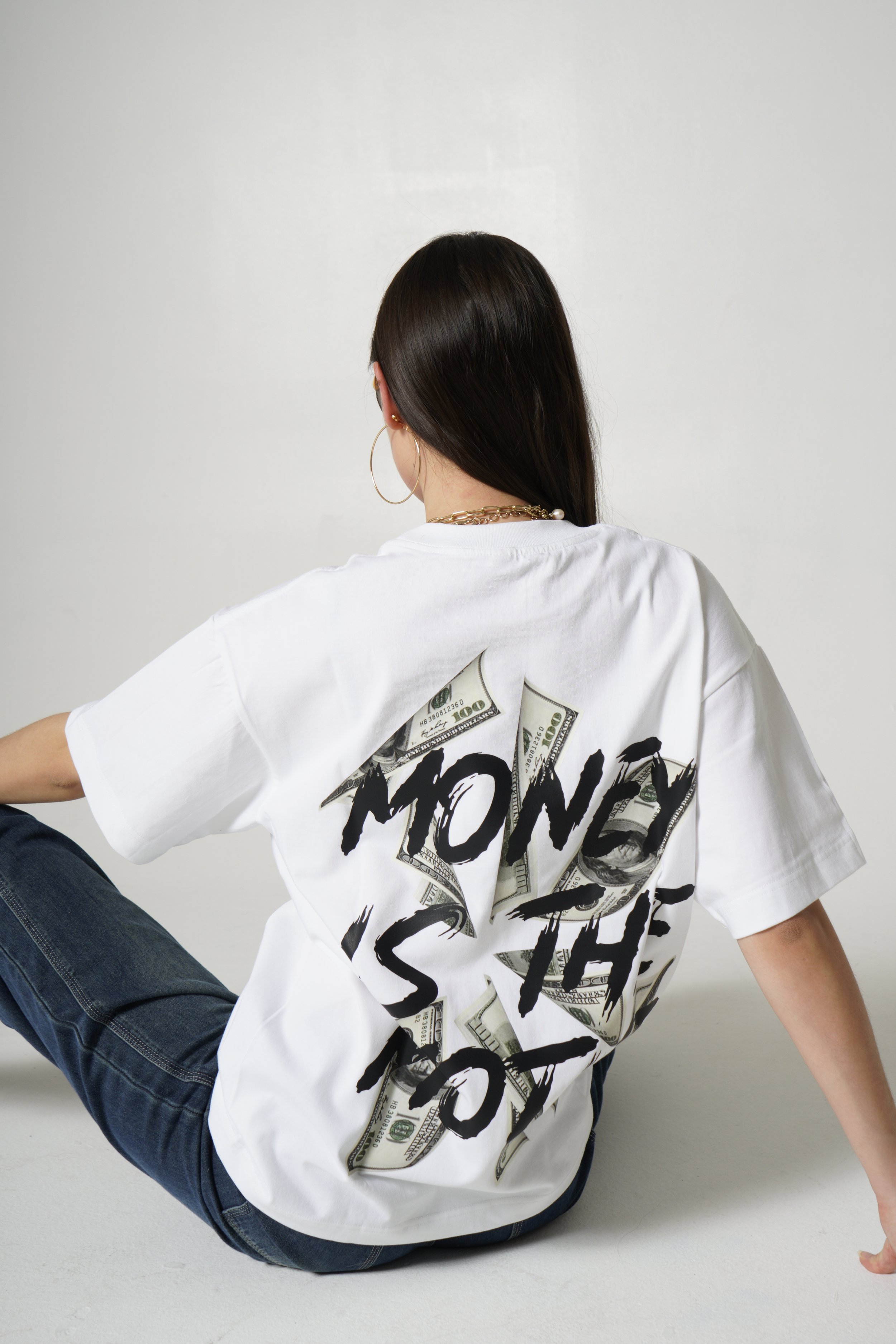 Model wearing white Coldust t-shirt showing back – stylish casual wear