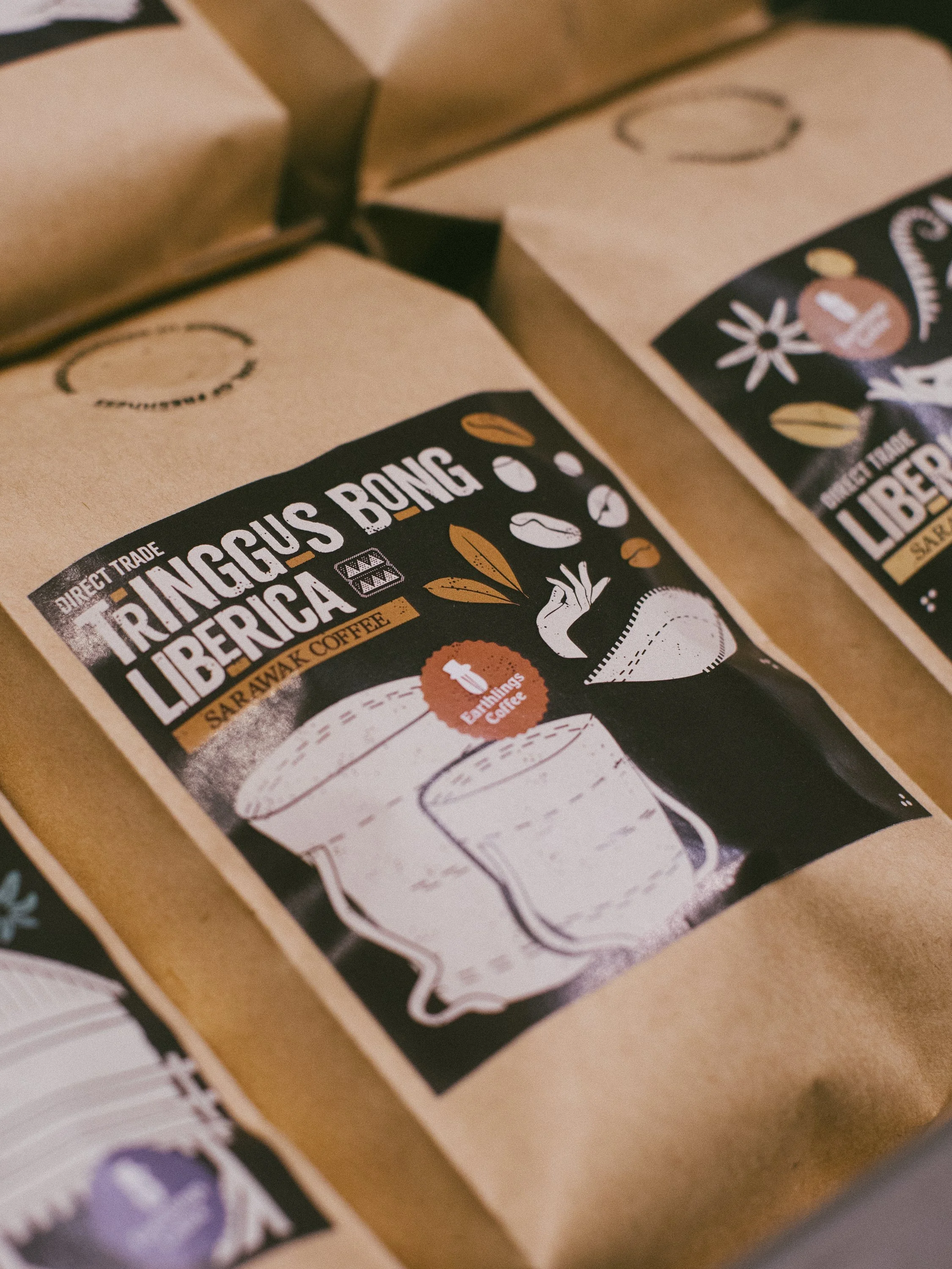 Package of Tringus Bong Liberica coffee with illustration of a glass of coffee and coffee beans in black, white, and brown colors.