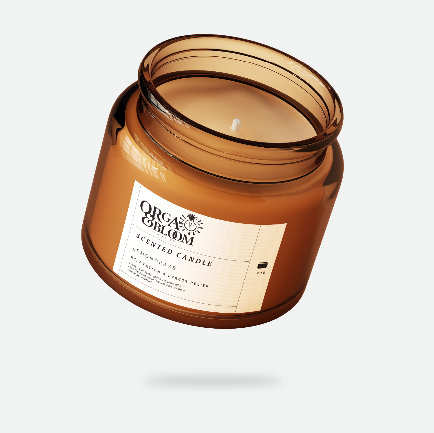 An orange glass jar candle with a white label that reads "Organic Bloom" and "Scented Candle" in black text, with the scent "Lemongrass" and description of relaxation and stress relief.