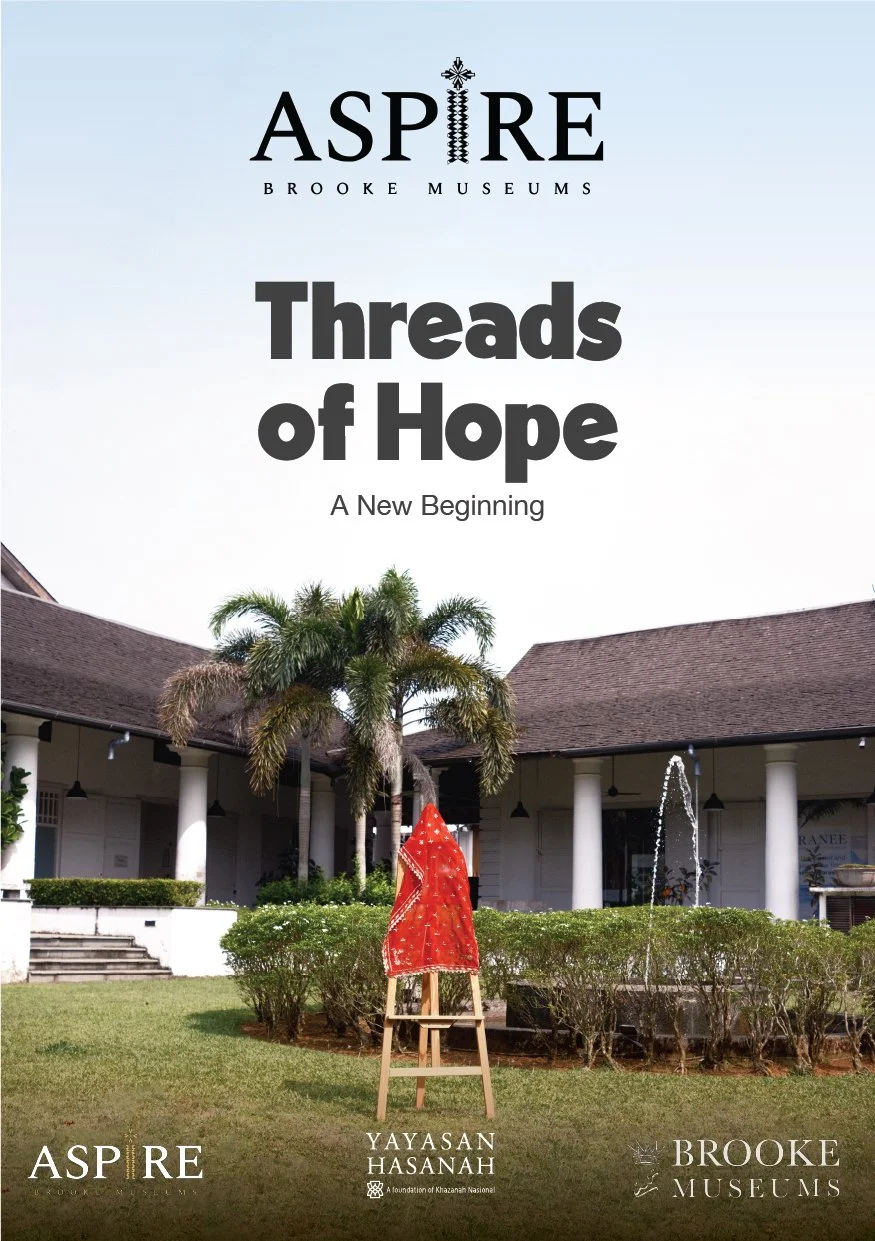 Poster for an exhibition titled "Threads of Hope" at Brooke Museum, featuring a red cloth on an easel outdoors near a building with columns, palm trees, and a water fountain.