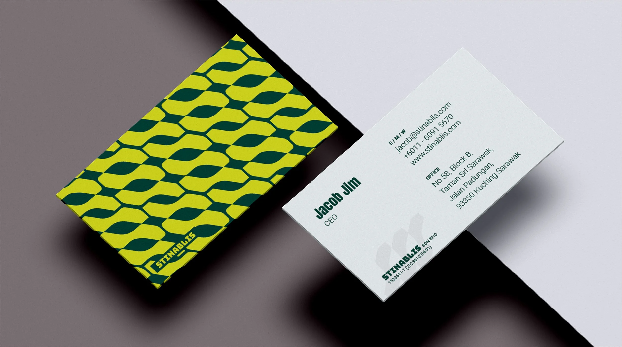 Business card with green and yellow geometric pattern on the back and contact information for Jacob Jim on the front, including name, title, address, phone number, email, and website.