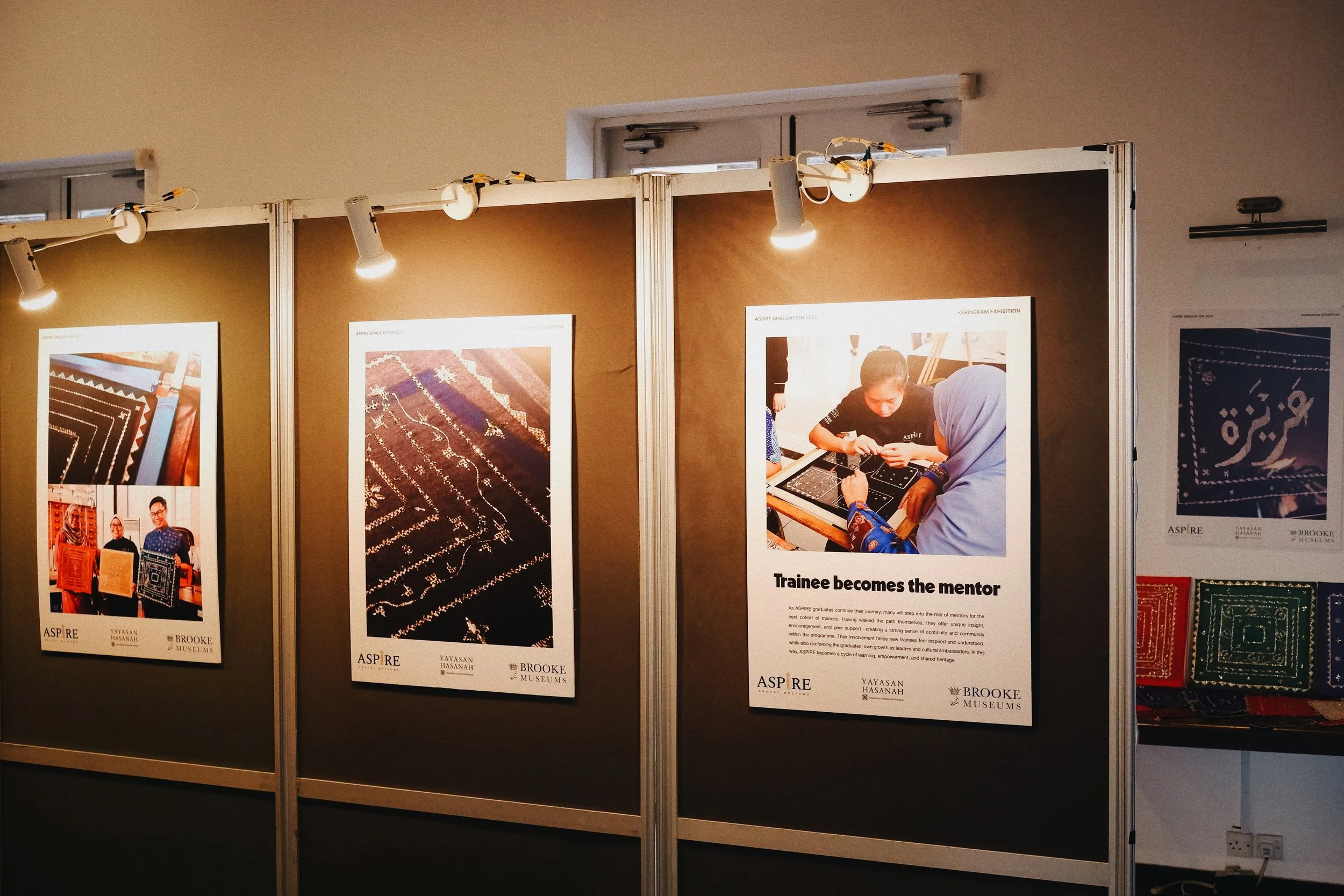 Exhibition display board featuring photographs of people working on traditional textile craft and textile patterns with informational captions.