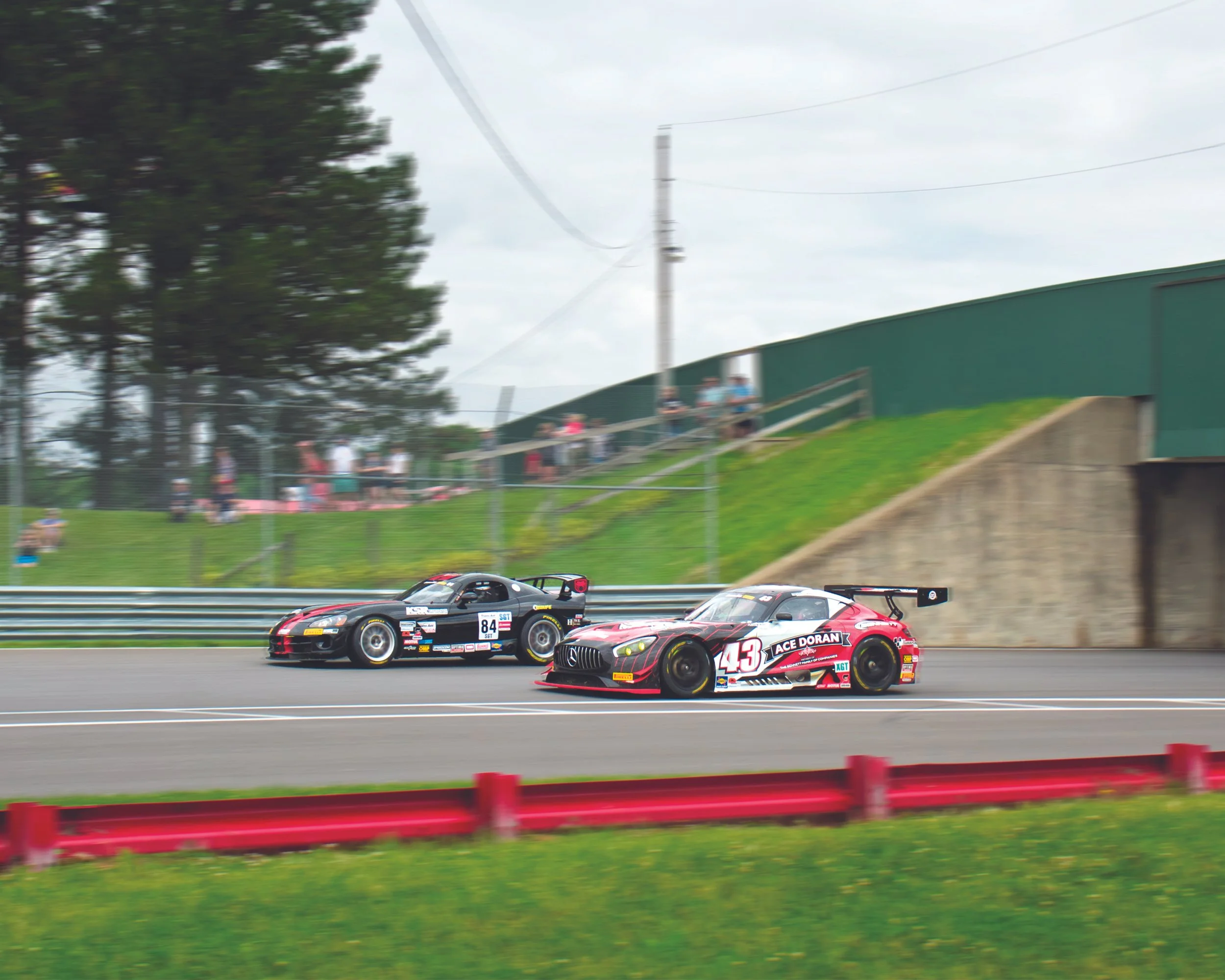 Photo taken at Mid Ohio raceway to commemorate their historic races where older models race in various period classes