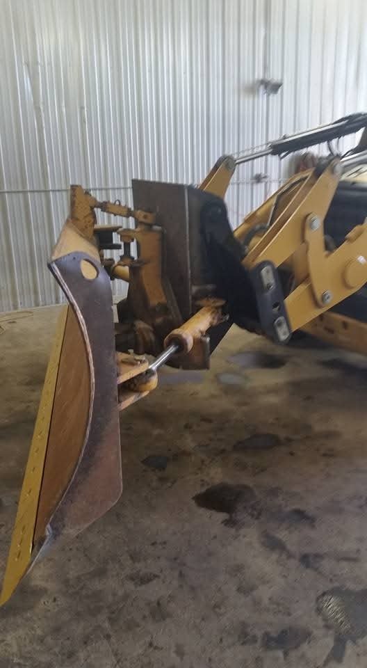 Close-up of a bulldozer blade attachment indoors