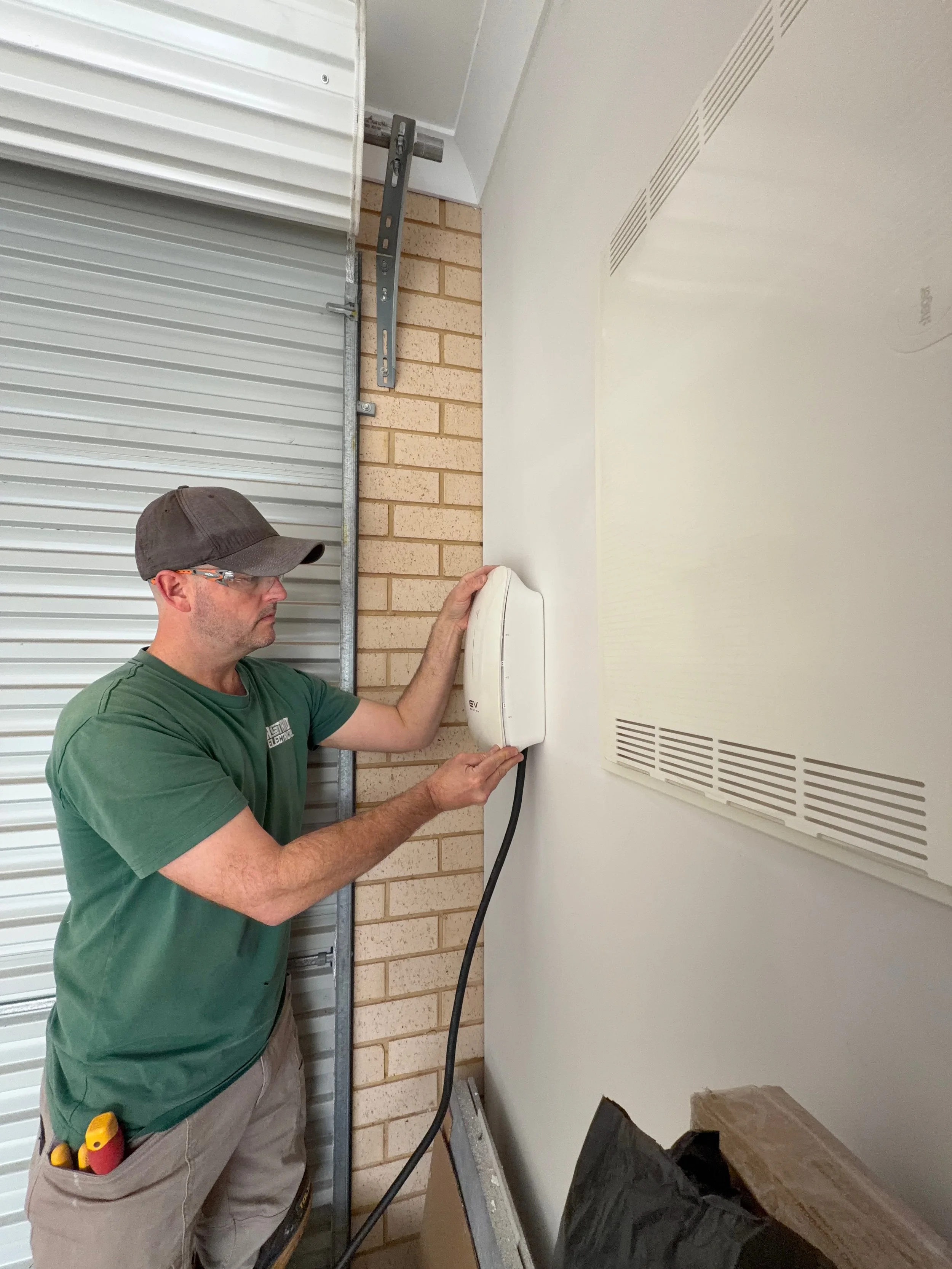 Electrician installing an EV Charger in a garage