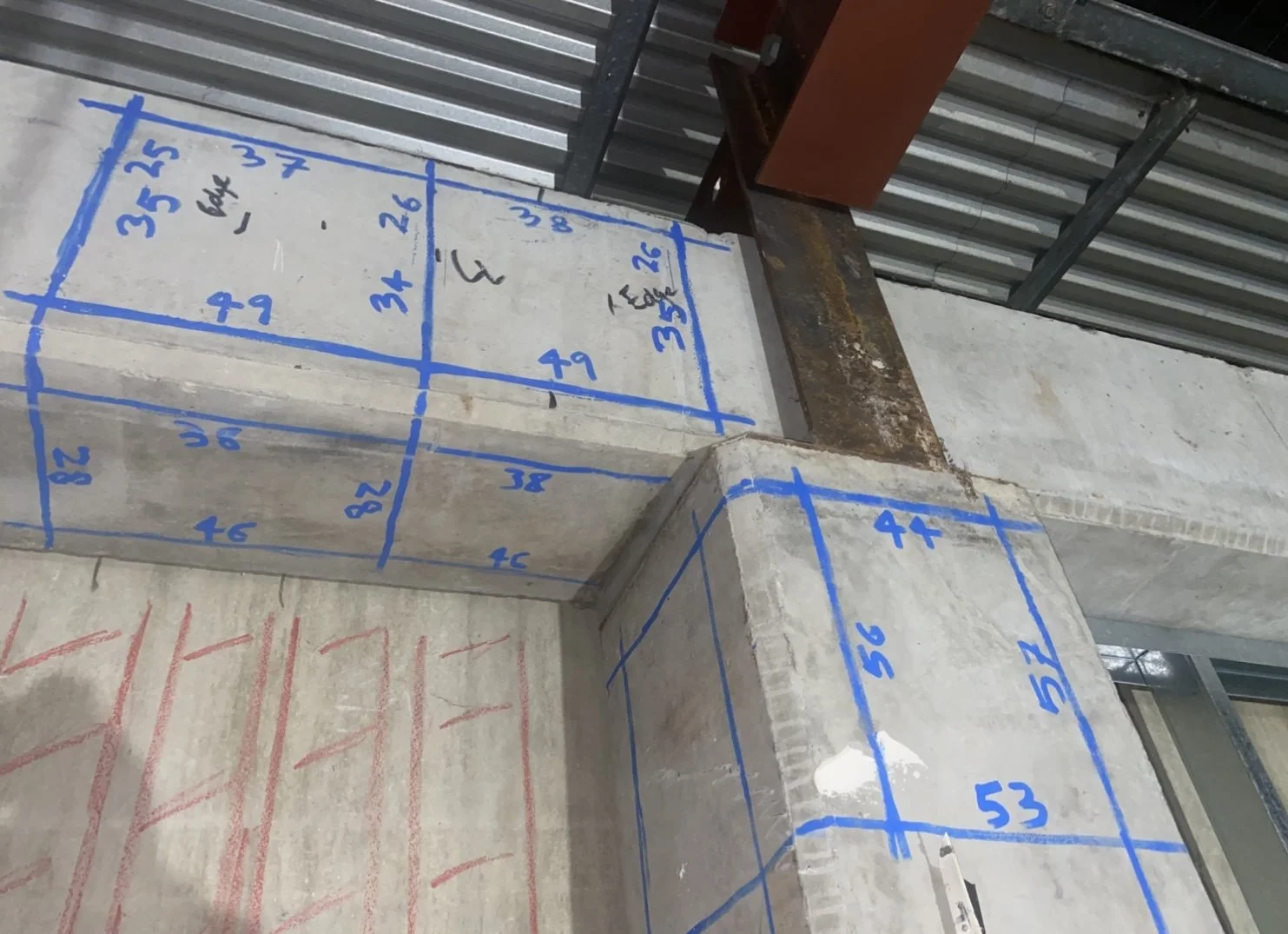Concrete beams with blue tape grid and cover readings