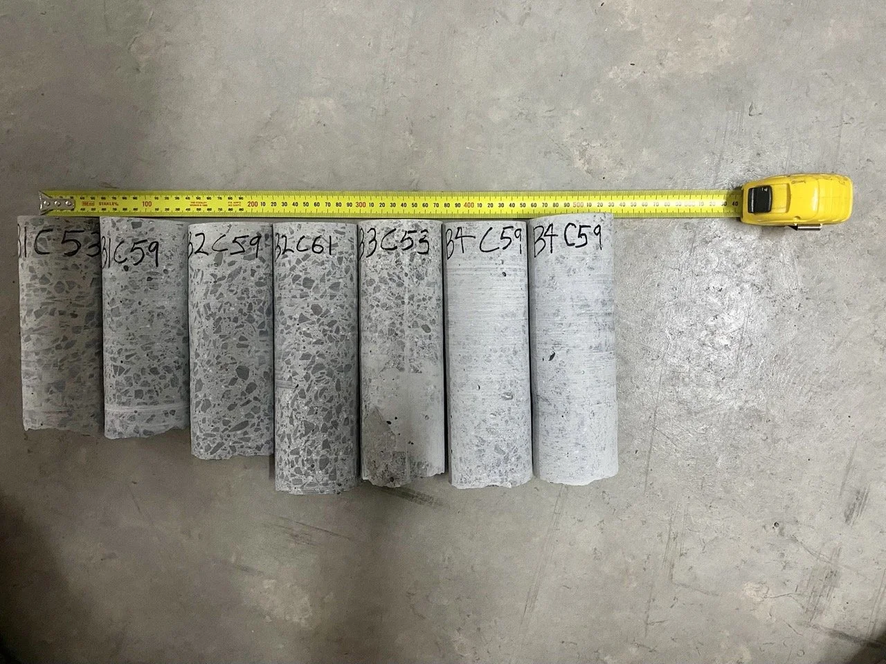 Row of labelled core samples with tape measure