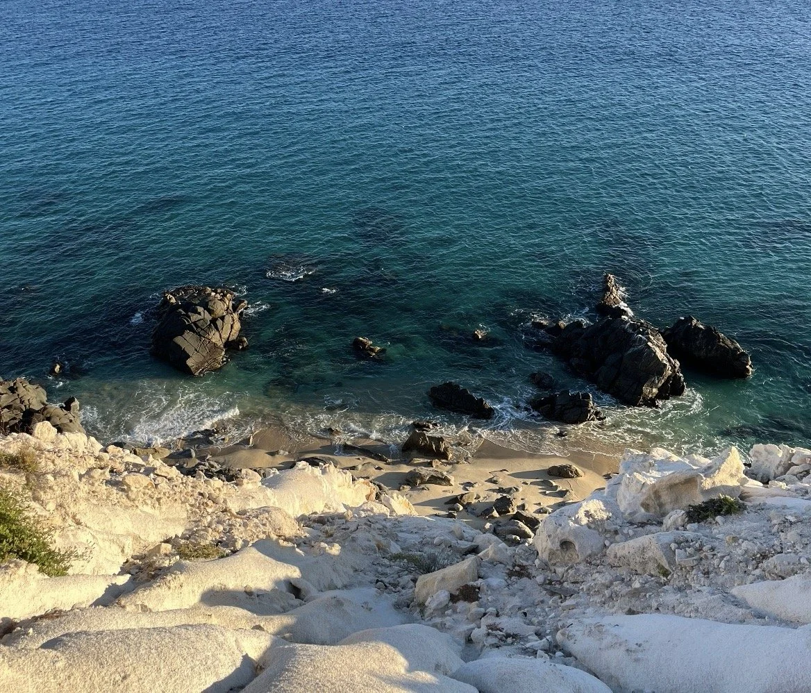 Zacatitos beach rocky with white cliffs and turquoise ocean water, seen from an elevated perspective.