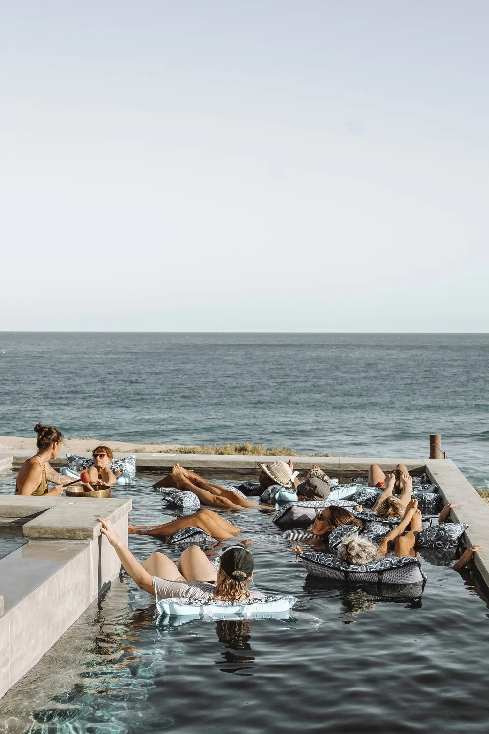 womens-retreat-group-in-pool-near-ocean.jpeg