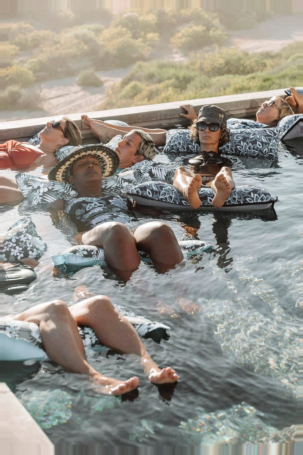 women-peacefully-floating-in-pool-water-ceremony-baja.jpeg