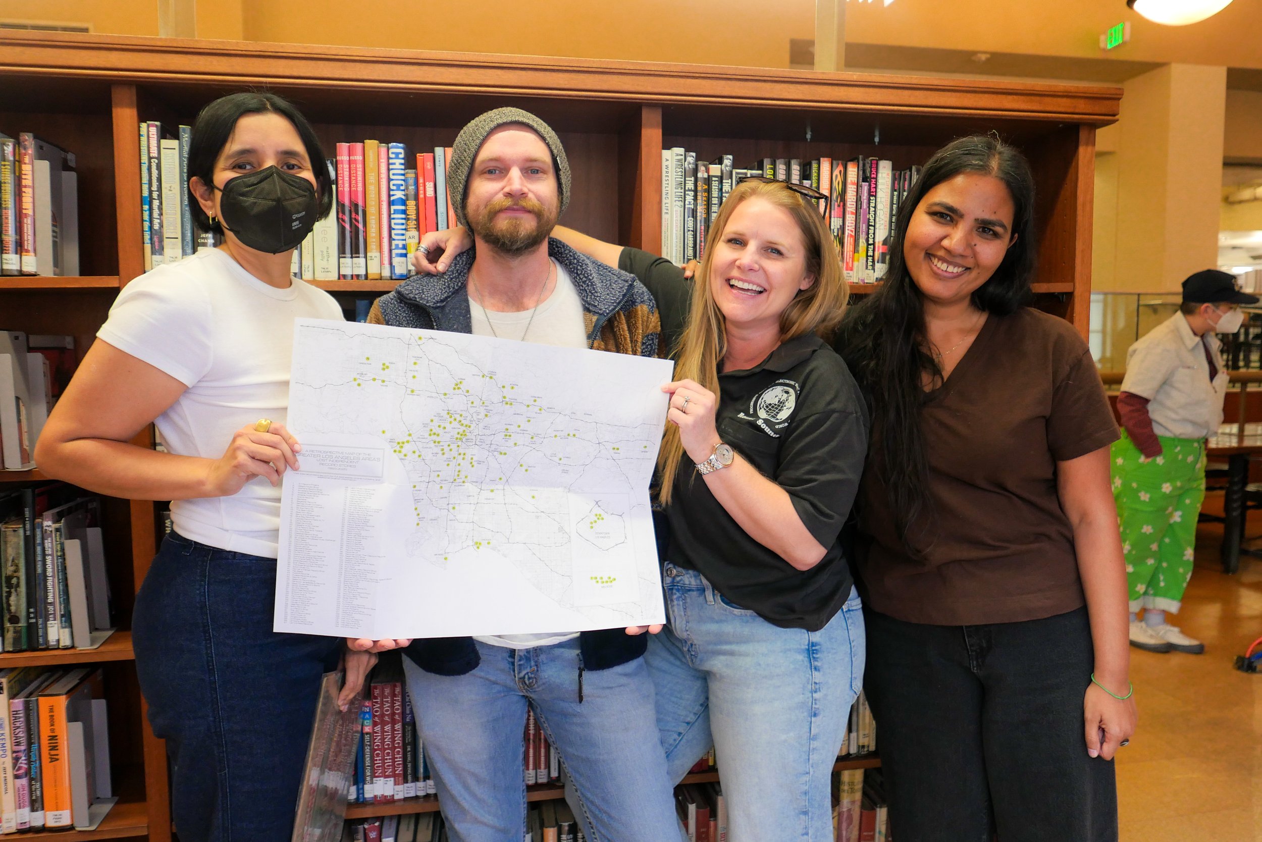 Two people posing with a map