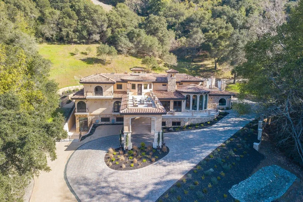 Aerial drone photo of a hillside Beverly Hills estate with a circular driveway.