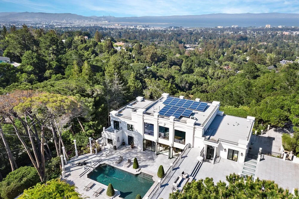 Aerial drone video of a modern Beverly Hills home with pool and city views.