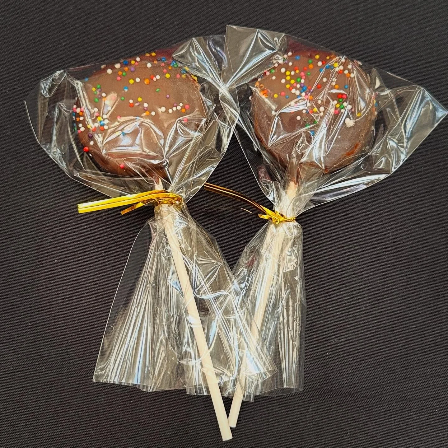 Cosmic Chocolate Cake Pops 🍩

Rich chocolate cake, dipped in milk chocolate coating, topped with cosmic rainbow sprinkles.