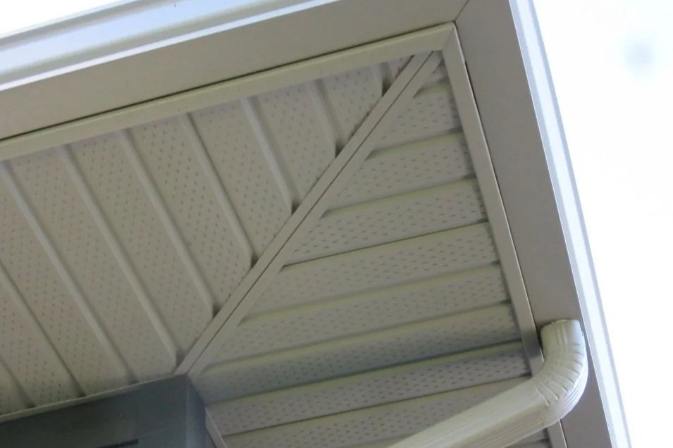 Ceiling with acoustic tiles, vent, and a corner of a smoke detector.