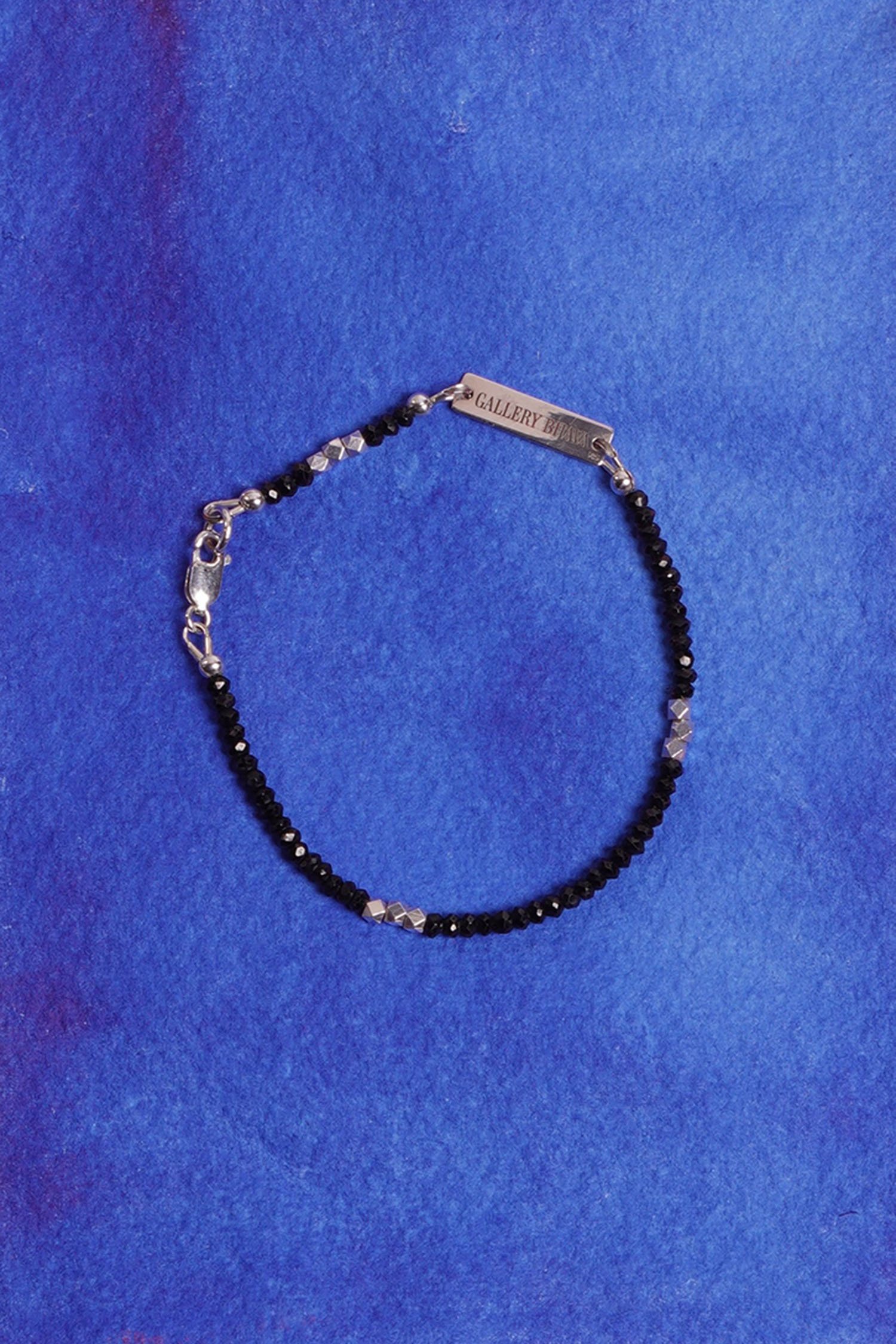 black spinel blue backround very close up.jpg