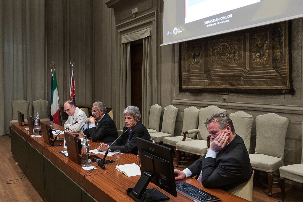 At the roundtable table: Sebastian Omlor, Christos Gortsos, Rolf H. Weber and Dirk Zetzsche. Aula Magna, Rector's Office Building, 8 May 2025. Photo: Andrea Pecchioli / Fotoproject.
