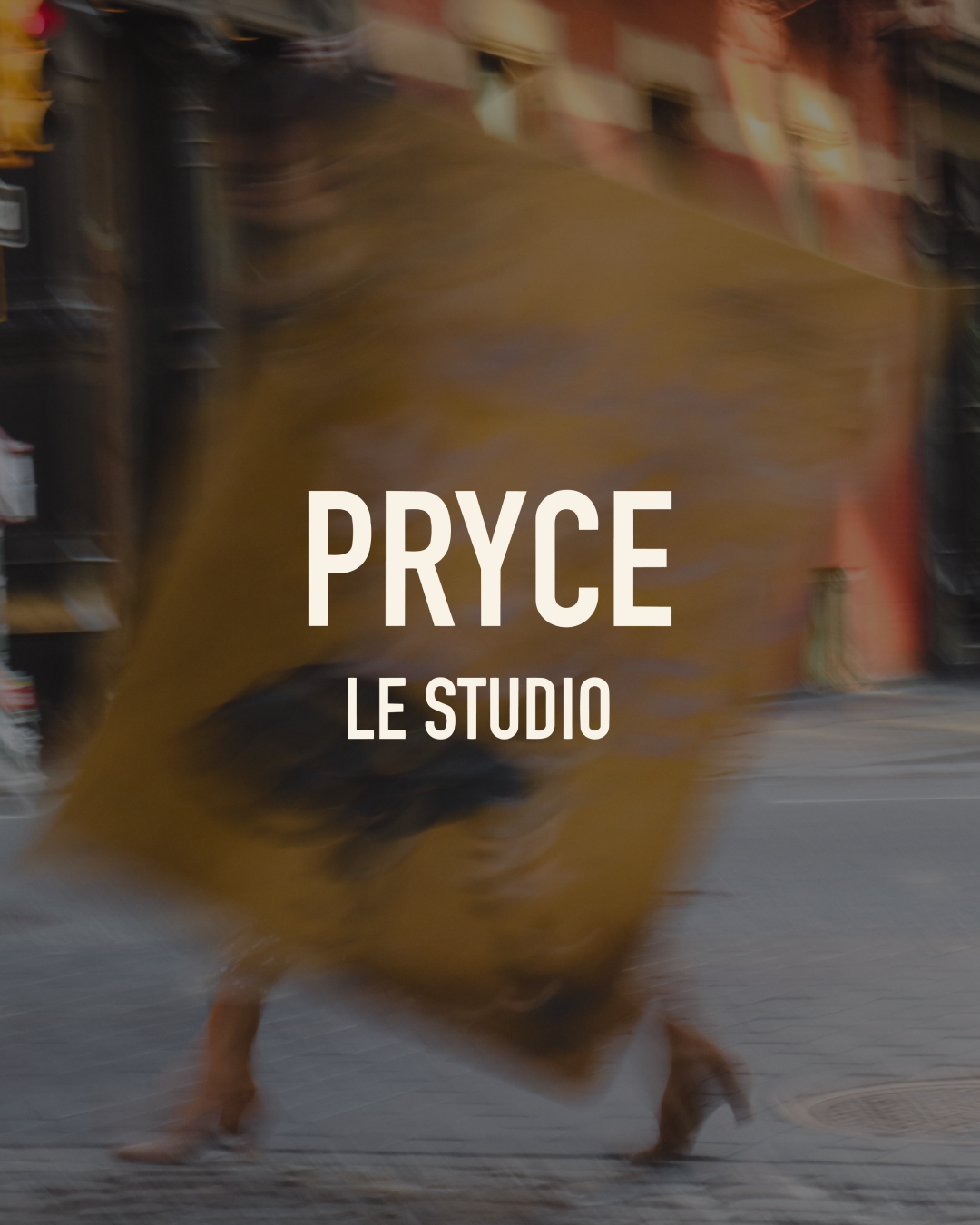 A person walking on a city street with a large, blurred, yellow-brown bag or object obscuring their face and upper body, with the text "PRYCE LE STUDIO" overlaid on the image.