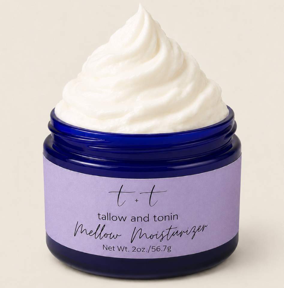 A blue jar of tallow and tonin mellow moisturizer with a white cream inside.