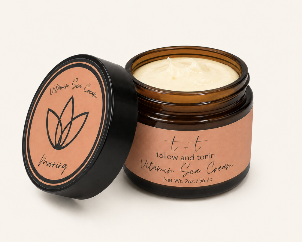 Open jar of Tallow and Tonin Vitamin Sea Cream with peach-colored label, black lid, and cream inside, against a plain background.