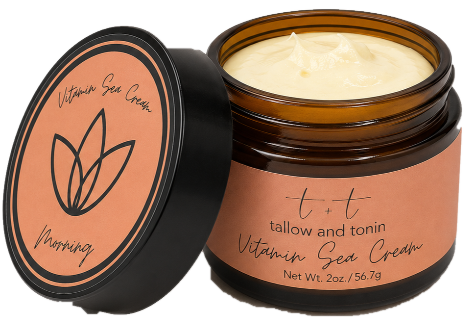 Open jar of Tallow and Tonin Vitamin Sea Cream with the lid leaning against it, showing the creamy product inside, terracota labels with minimalist logo and text.