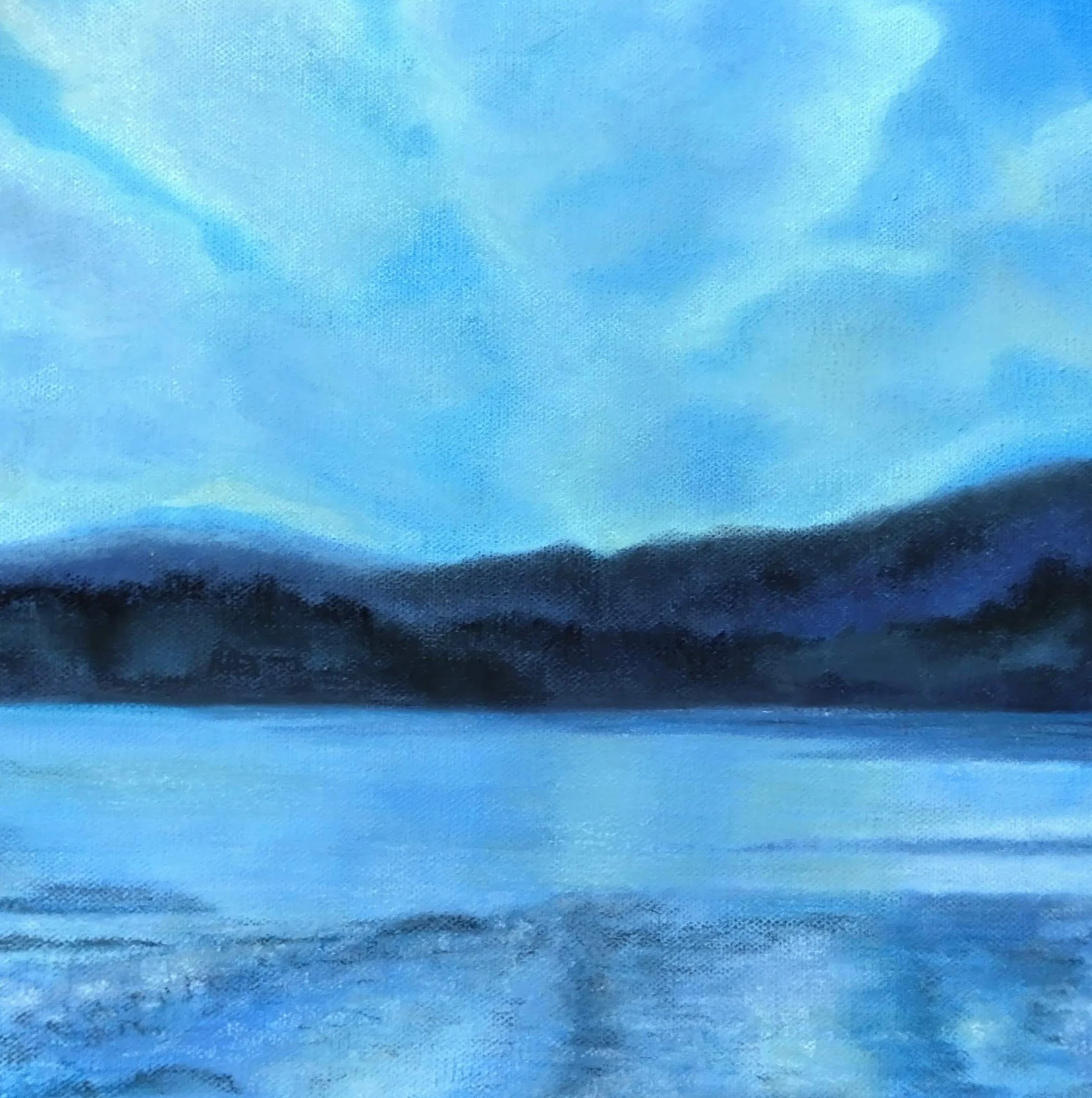 A soft pastel skyscape in shades of blue, showing the sea, a range of hills, and a blue and white sky
