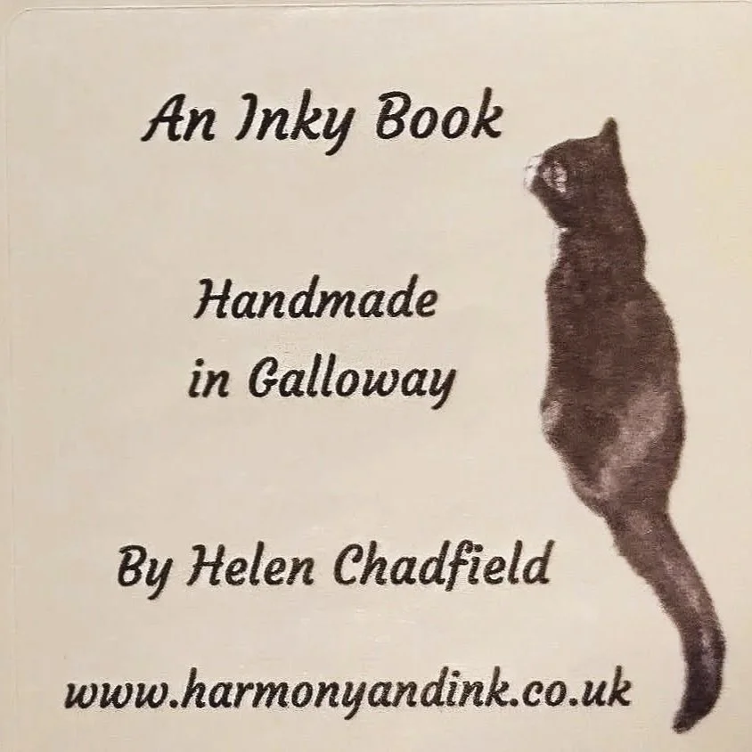 A book label in cream with a black and white cat and information about Inky Books