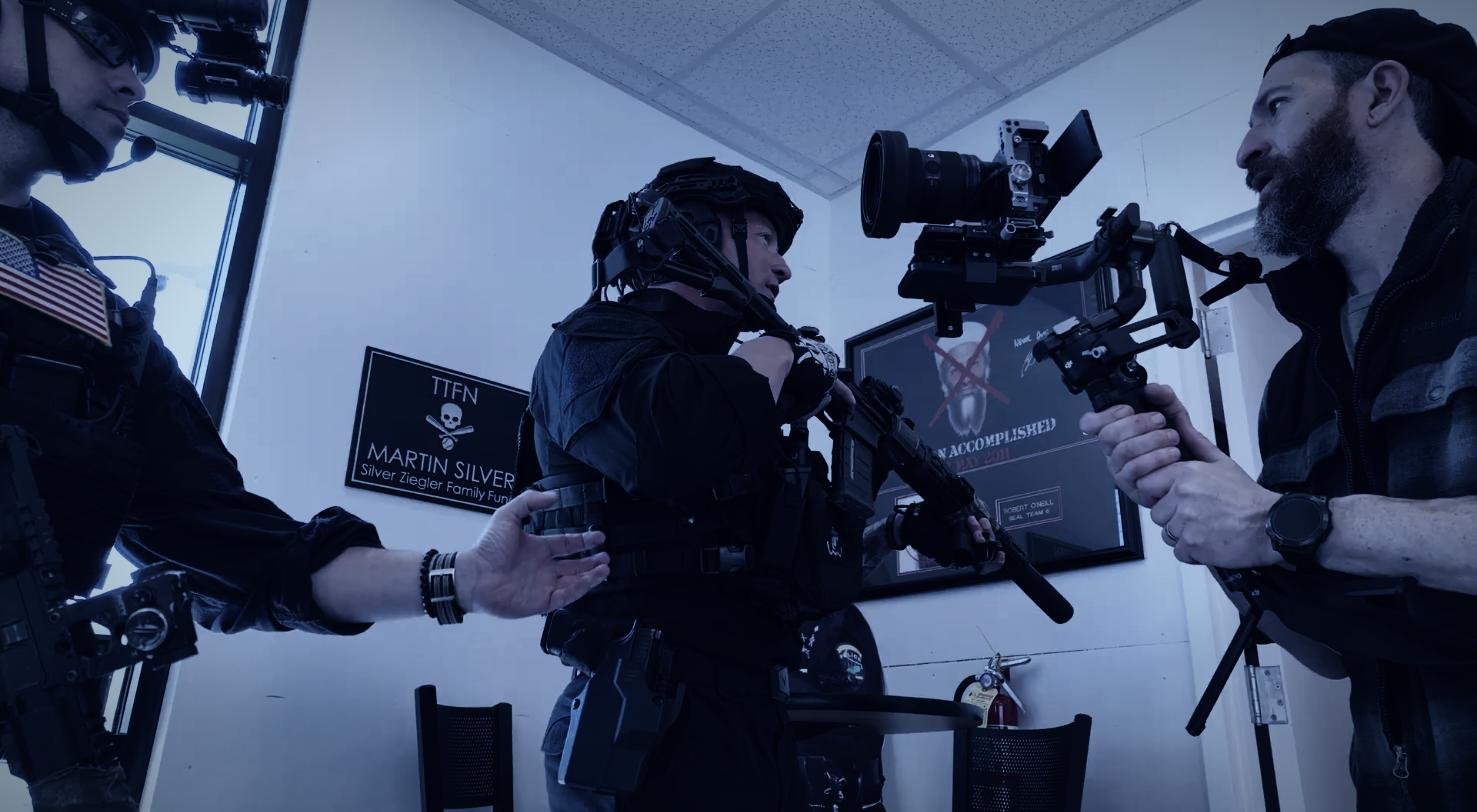 CXIX crew filming an operator in tactical gear with a cinema camera on a gimbal rig