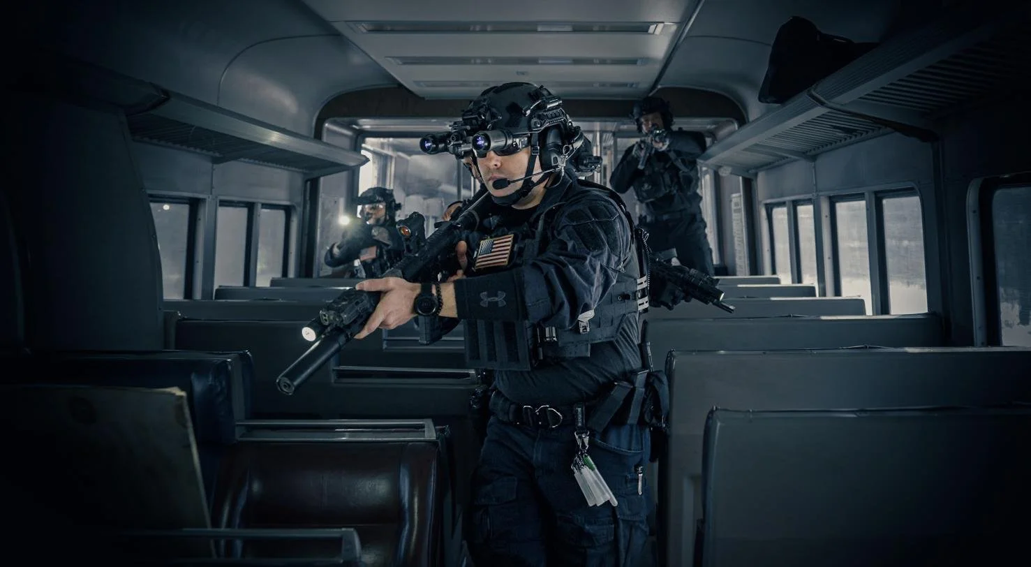 Long Island SWAT Challenge, shot by CXIX: group of heavily armed tactical soldiers conducting a raid inside a bus, wearing tactical gear and night vision equipment.