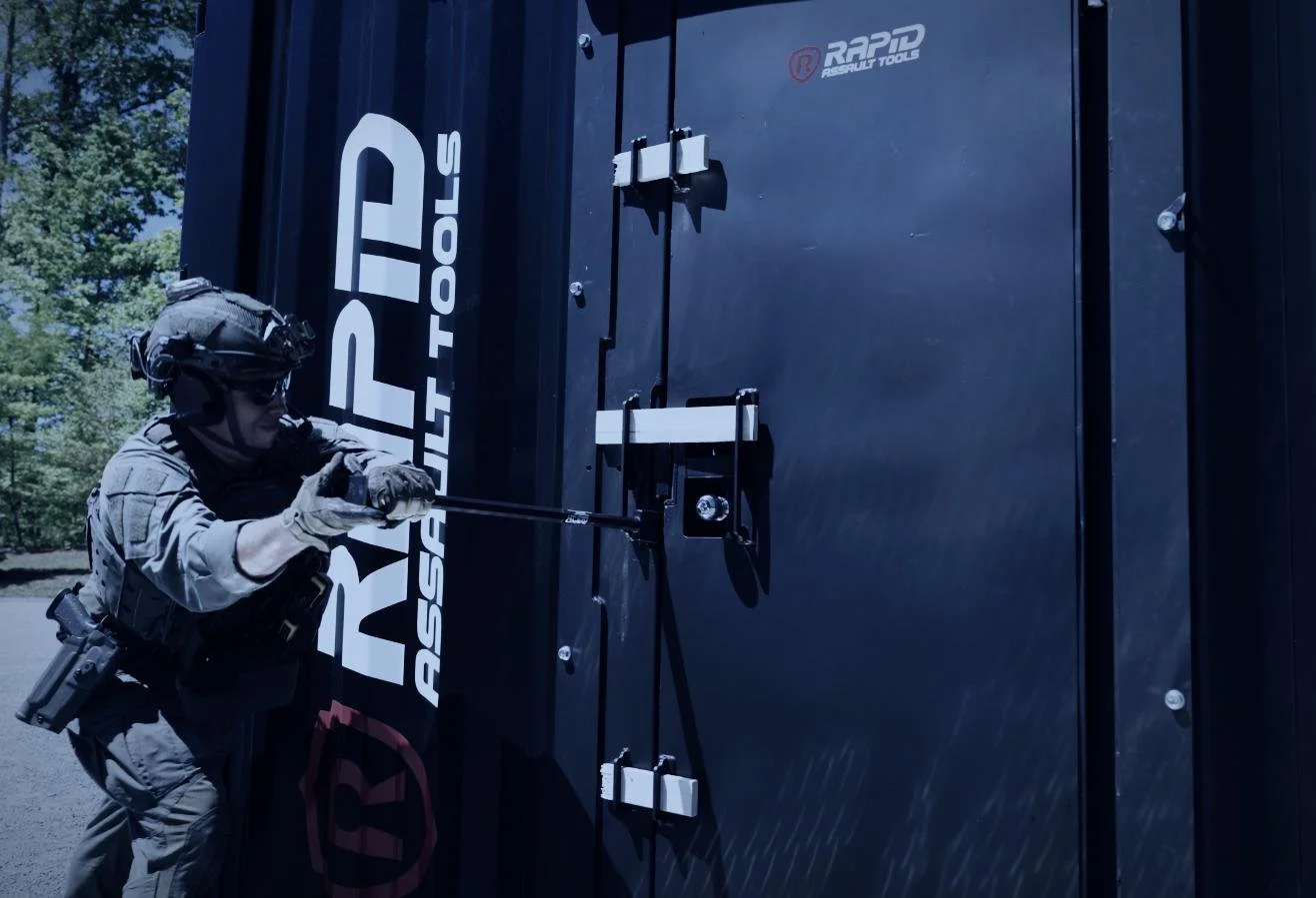 Rapid Assault Tools shoot by CXIX: a tactical officer with a helmet and tactical gear prying open a large black lock with a crowbar.